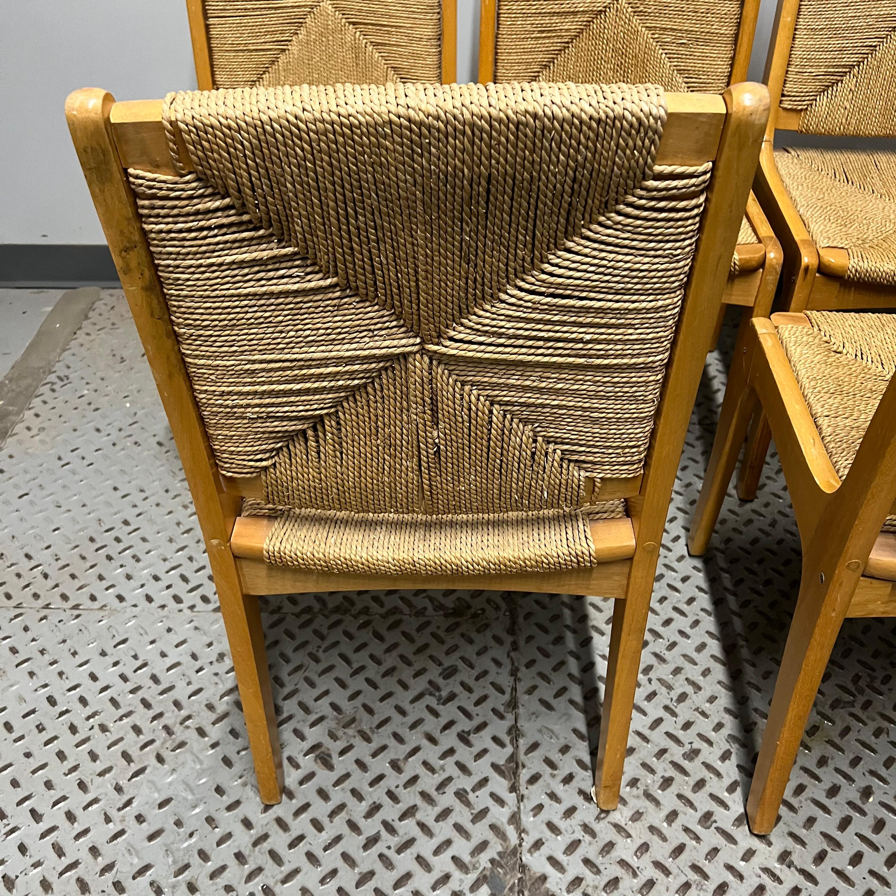 These dining chairs feature an oak frame with woven rush seats and backs.  They have a slight similarity to Charlotte Perriand or Vico Magistretti designed chairs.  They are unmarked.  They were purchased by the interior designer to a prominent