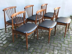 Set of Six Mid Century Walnut Spindle Back Dining Chairs with Black Vinyl Seats