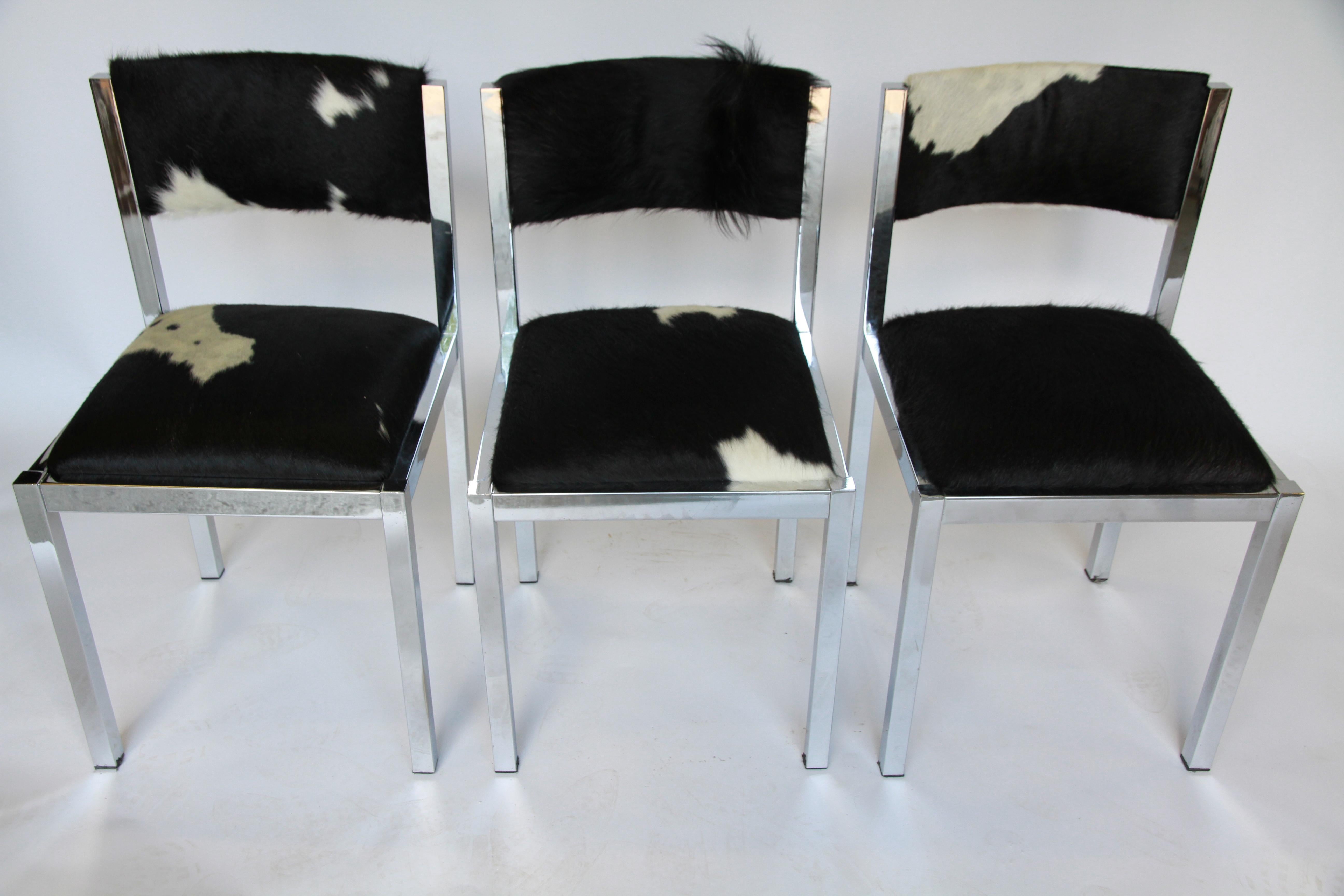 A set of six armless midcentury dining chairs from France. Square chrome frame with seat and back newly upholstered in black and white cowhide. A perfect addition to the upscale home or ranch.