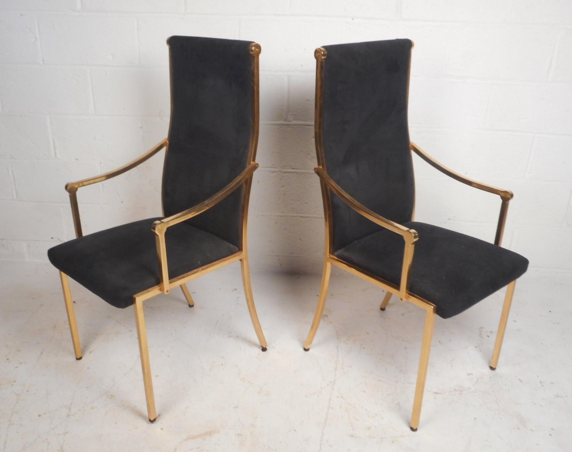 This beautiful set of six vintage modern dining chairs include two arm chairs and four dining chairs. Sleek design with a heavy brass frame and navy blue velvet upholstery. A unique angled high back rest, thick padded seats, and angled back legs