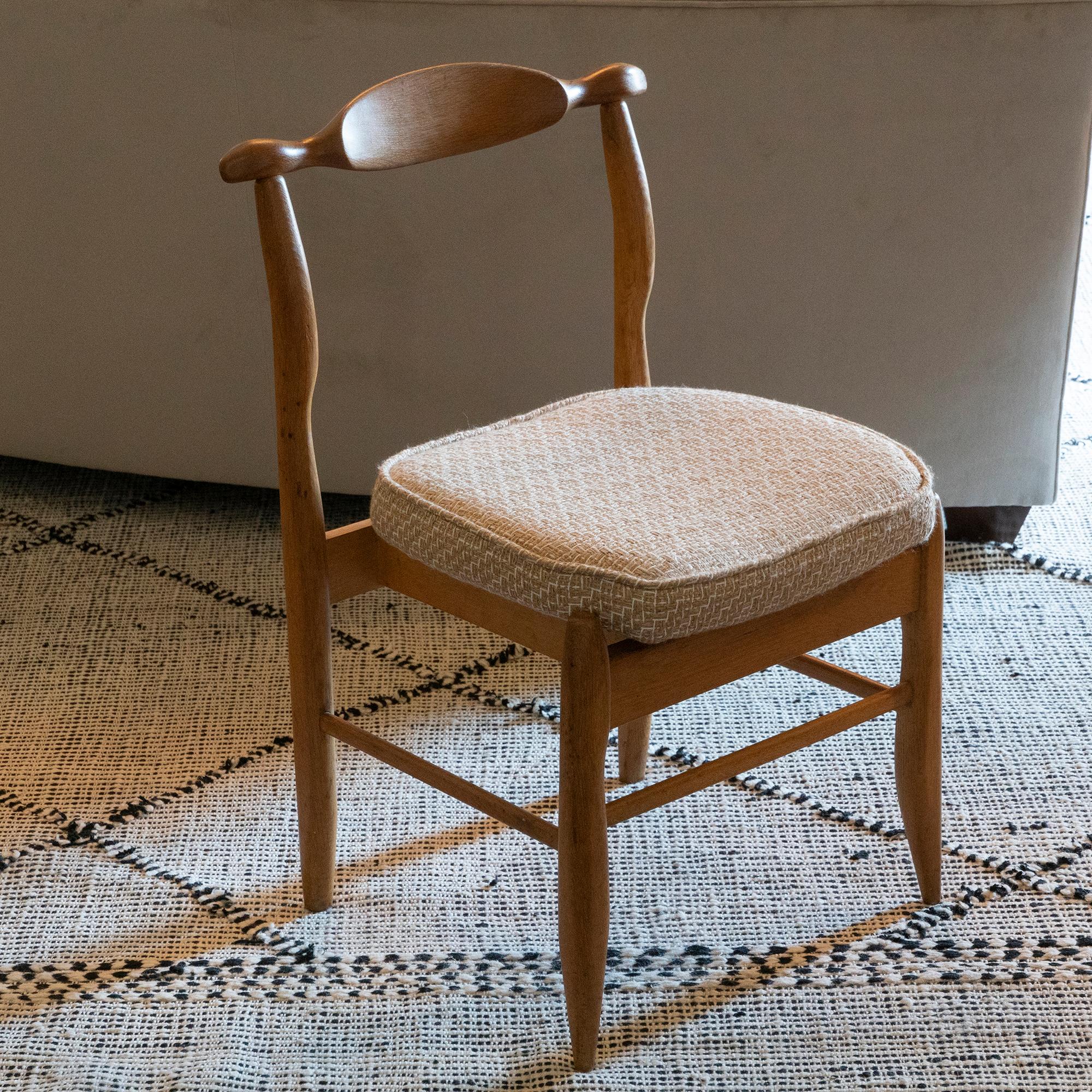 Set of six oak dining chairs by Guillerme & Chambron, newly reupholstered in bouclè beige and ivory wool fabric, structure with perfect vintage patina, one chair have some stain on the back as showed on image 18, France, circa 1960.