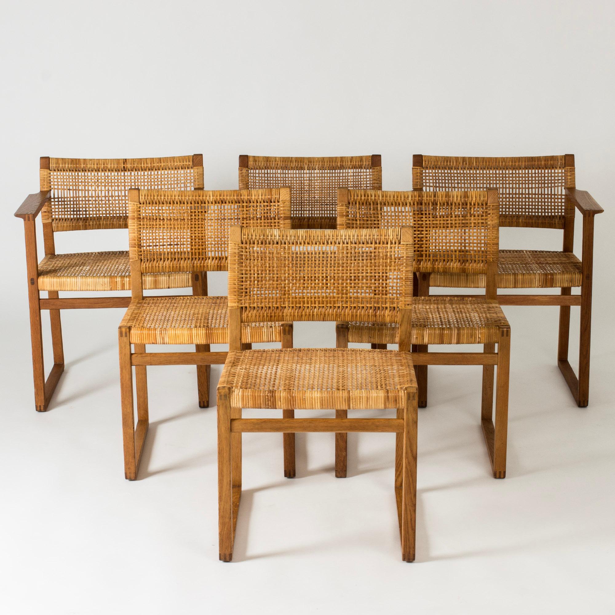 Set of six amazing oak and rattan dining chairs by Børge Mogensen. Beautiful silhouettes and materials. Two of the chairs have armrests.

Height 75 cm, Width 47.5 / 60 cm, Depth 48 / 49 cm