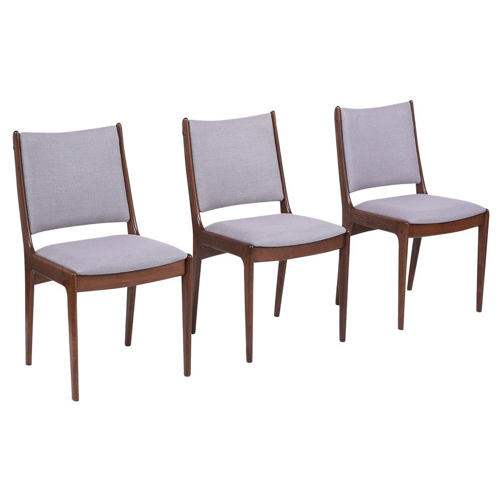 An extraordinary Set of Six Modern Danish Style Dining Chairs handcrafted out of teak wood and features sleek carved frame design newly stained in a walnut color with a lacquered finish. This set of side chairs comes with high backrests and