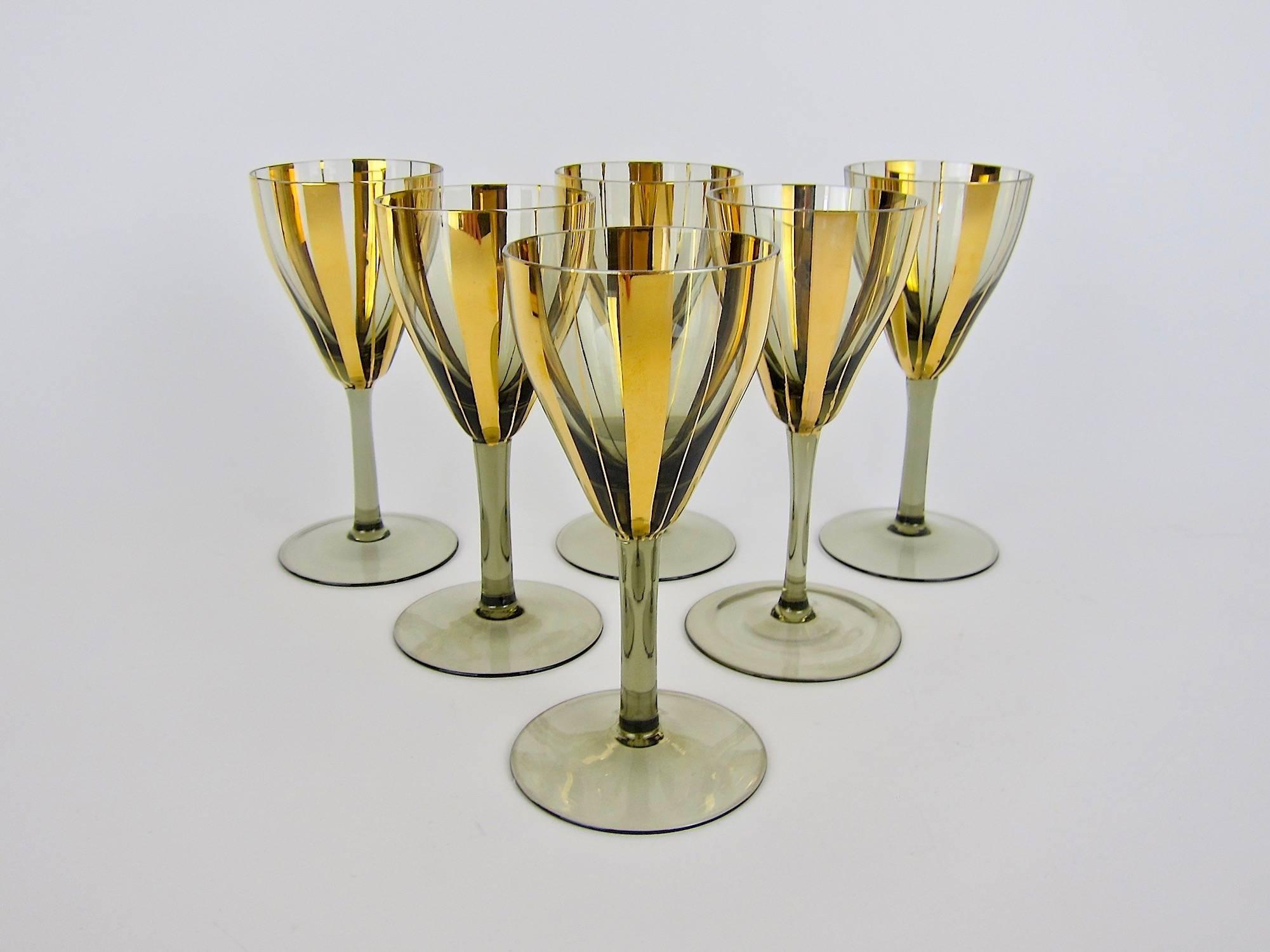 A stylish set of six vintage glasses in smoked glass with gold stripes dating, circa 1970s. Unmarked and in very good condition, measuring 6 in. H x 2.75 in. diameter (at rim); each glass holds 4.5 oz. filled to the rim.