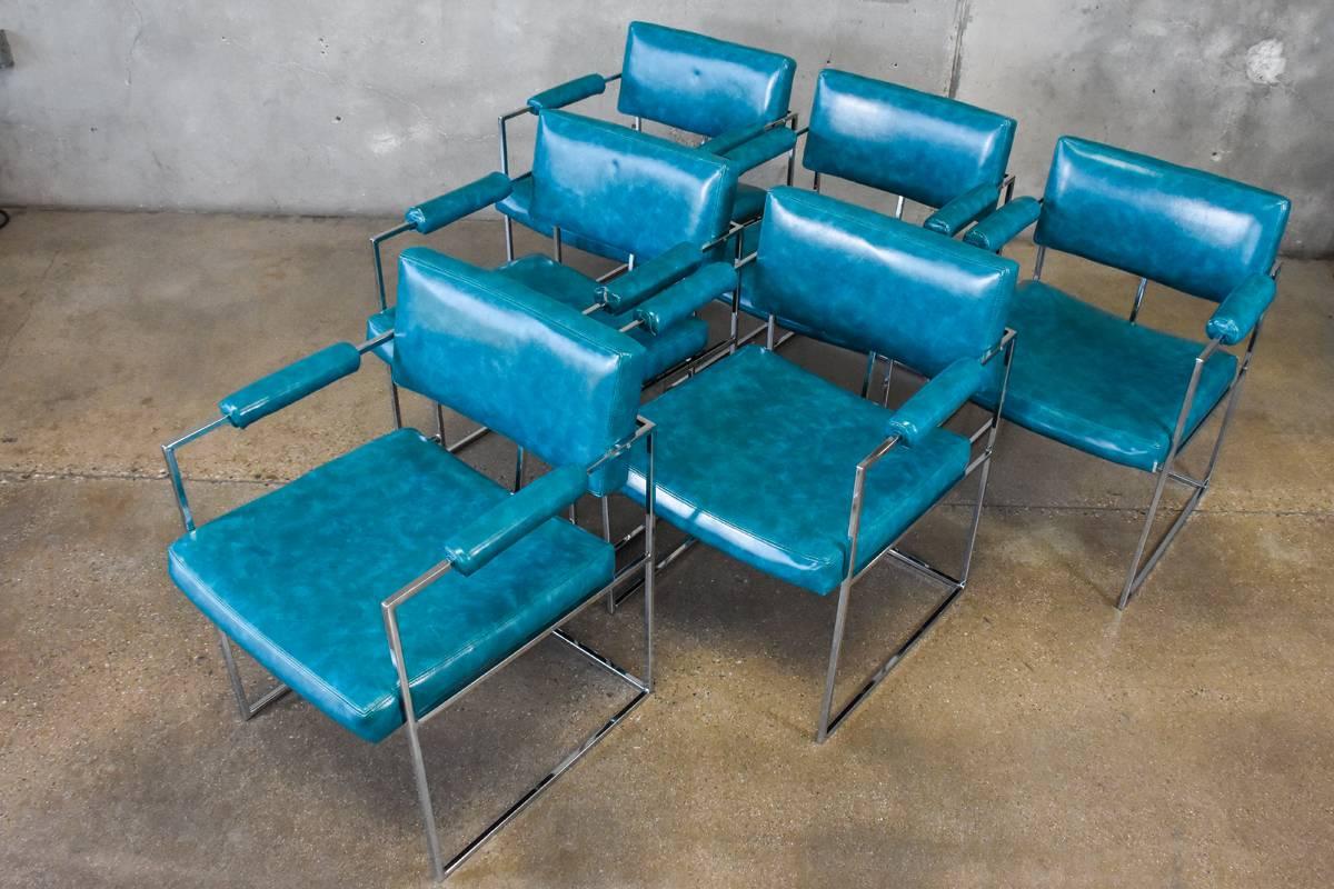 A set of six chrome cube frame chairs designed by Milo Baughman for Thayer Coggin. These examples are upholstered in their original dark turquoise vinyl. Its usable as is, though there are some minor splits on corners and arms as pictured. The