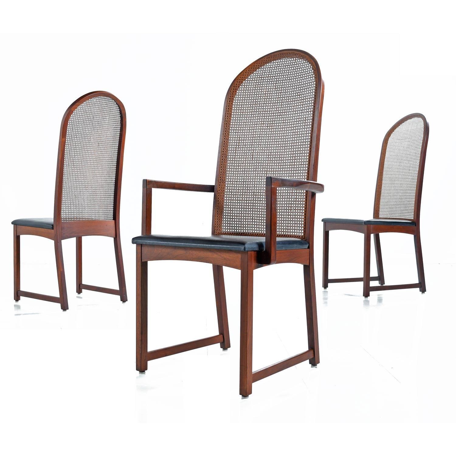 Set of six Milo Baughman for Dillingham walnut dining chairs. This set of six Mid-Century Modern chairs includes two captain's chairs with arms and four armless side chairs. Arched backs with sleek minimalist design, walnut frames, rattan backs and