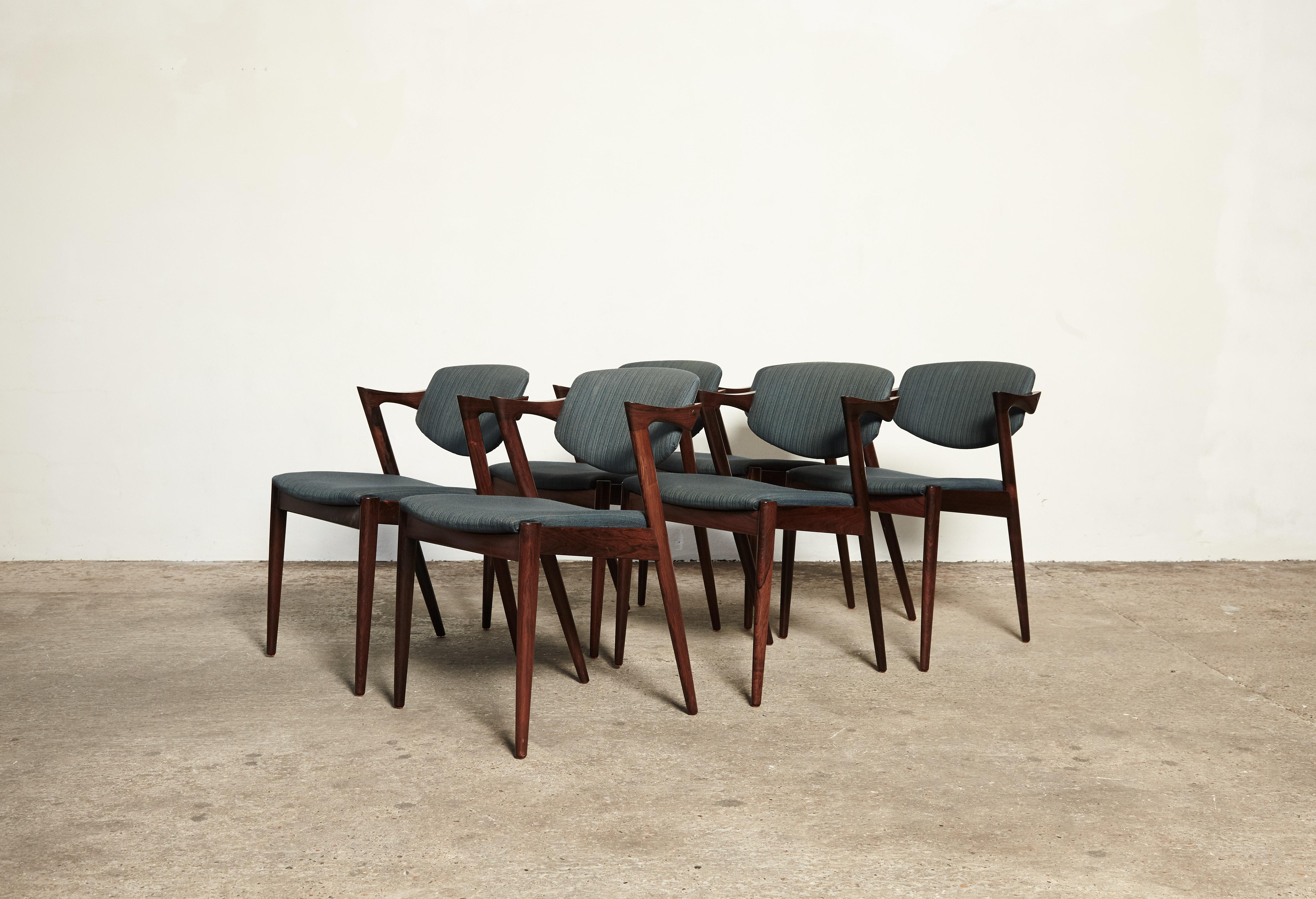A set of six Model 42 rosewood dining chairs by Kai Kristiansen for Schou Andersen, Denmark. Tilting backrest. Original fabric seat covers - we offer a recovering service if you would like to replace the fabric. Very good condition. Ships worldwide