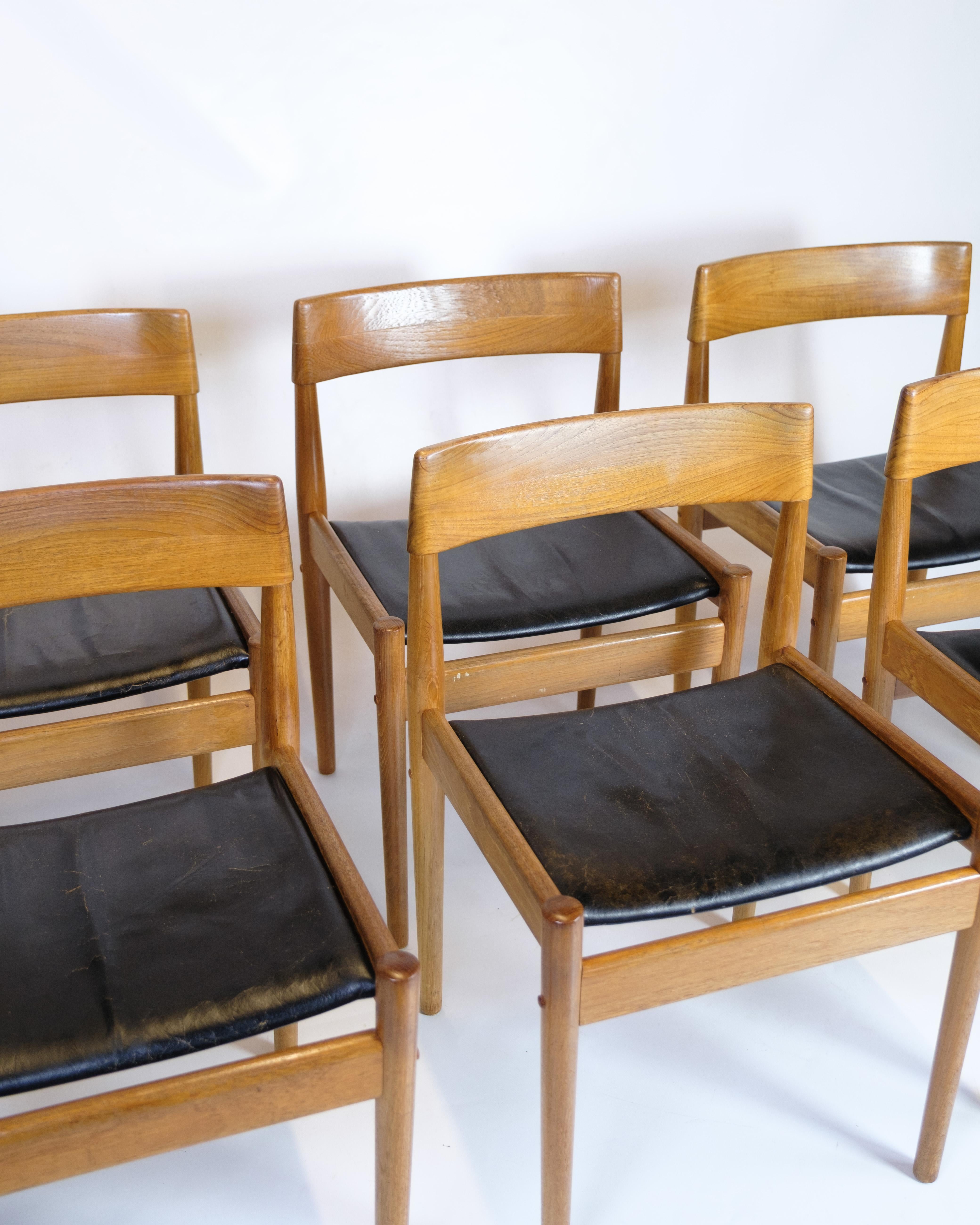 Set of six dining chairs made of teak with seats in original upholstered black leather. The chair is designed by Grete Jalk and produced by Poul Jeppesen. The chair was given the model number P J 3-2. The chairs are from the 1960s and are in great