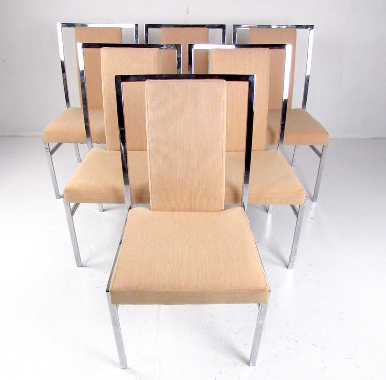 This set of six upholstered dining chairs features stylish heavy chrome frames with light yellow fabric. Quality contemporary modern dining chairs add Mid-Century Modern style to home dining room or occasional office seating. Please confirm item
