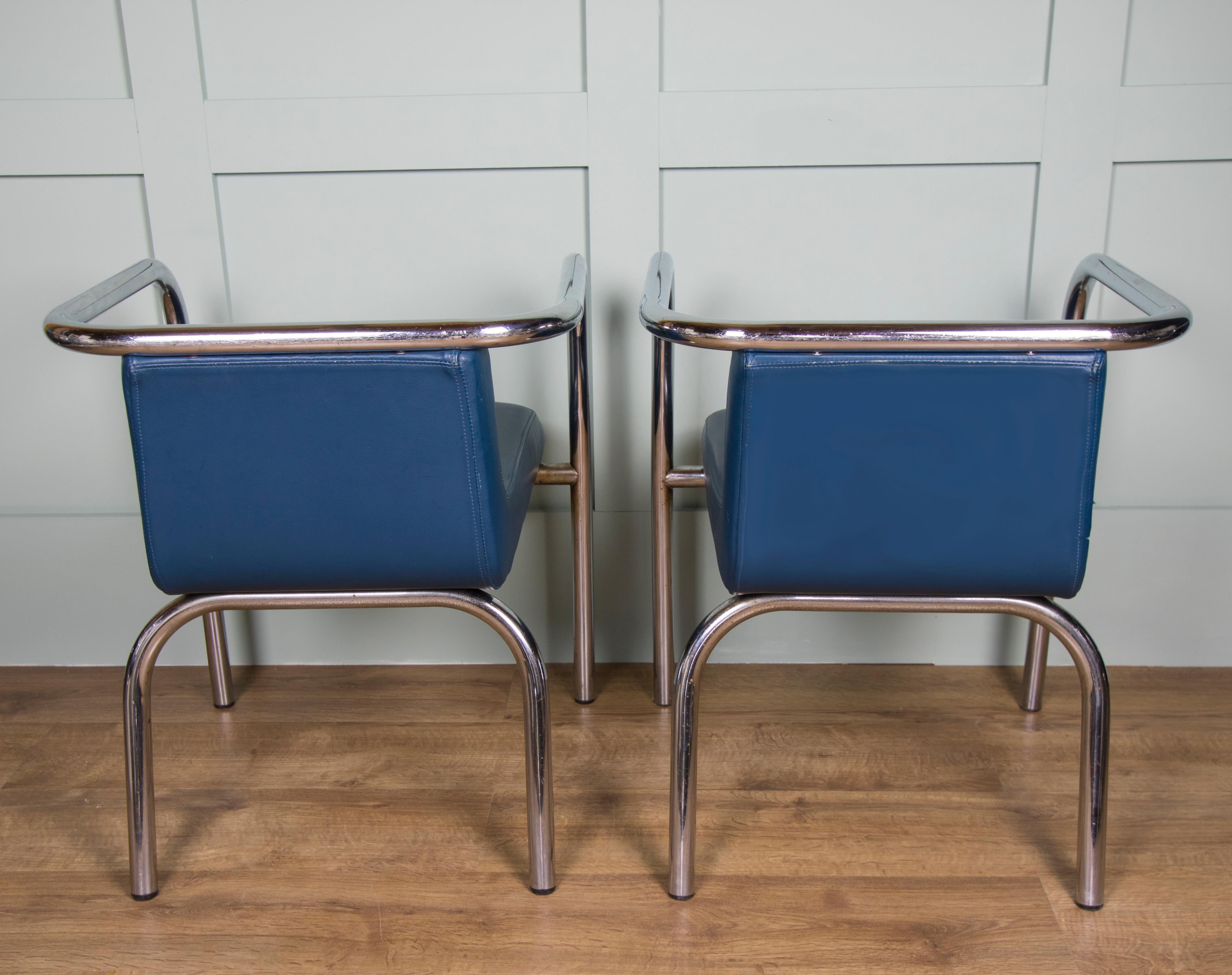 This set of six chairs made from tubular steel frames and upholstered with soft royal blue leather seats. These chairs have low backs with comfortable padded seats. There is some patina to the frames as they are original, believed to date from