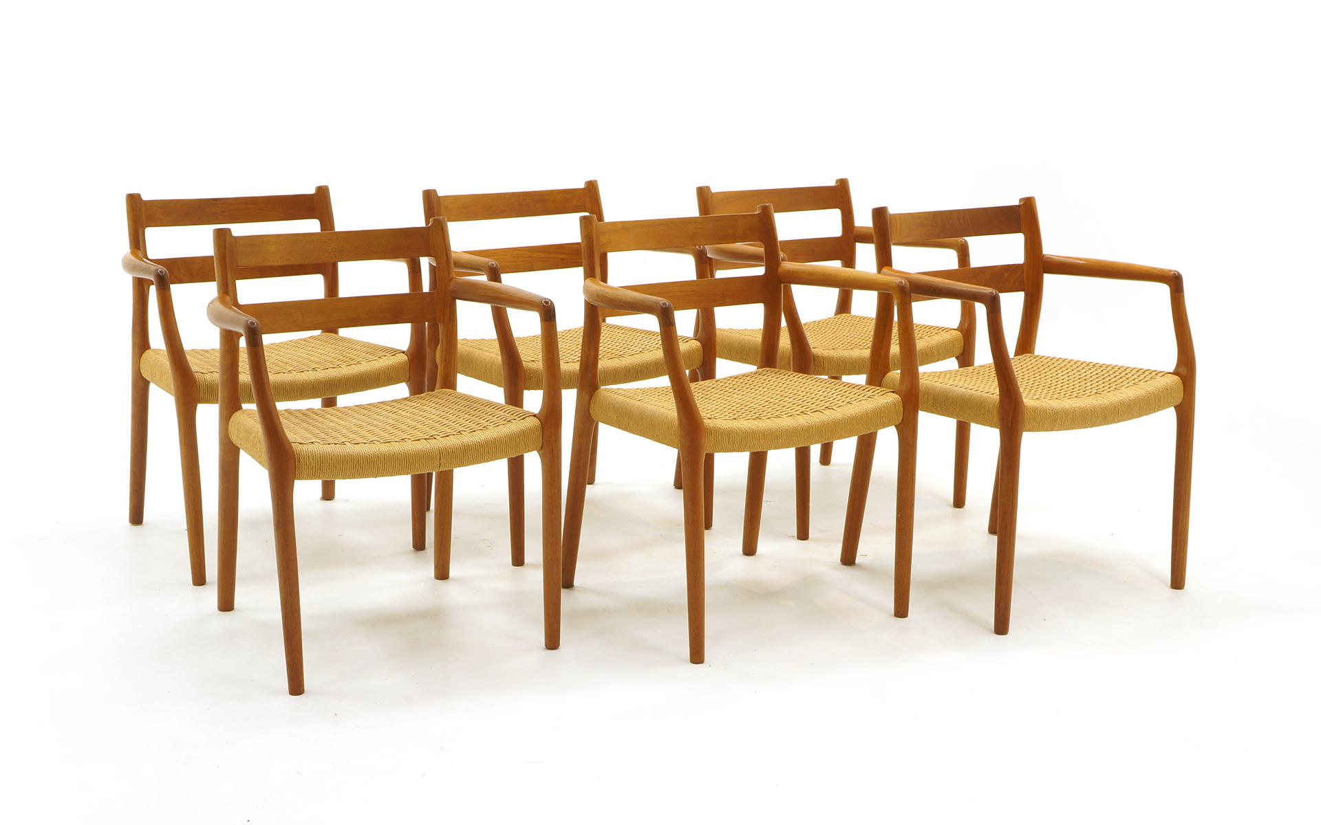 Set of 6 Danish modern teak dining chairs, all armchairs, by Moller. Original handwoven papercord seats. All in very good original condition. Ready to use.