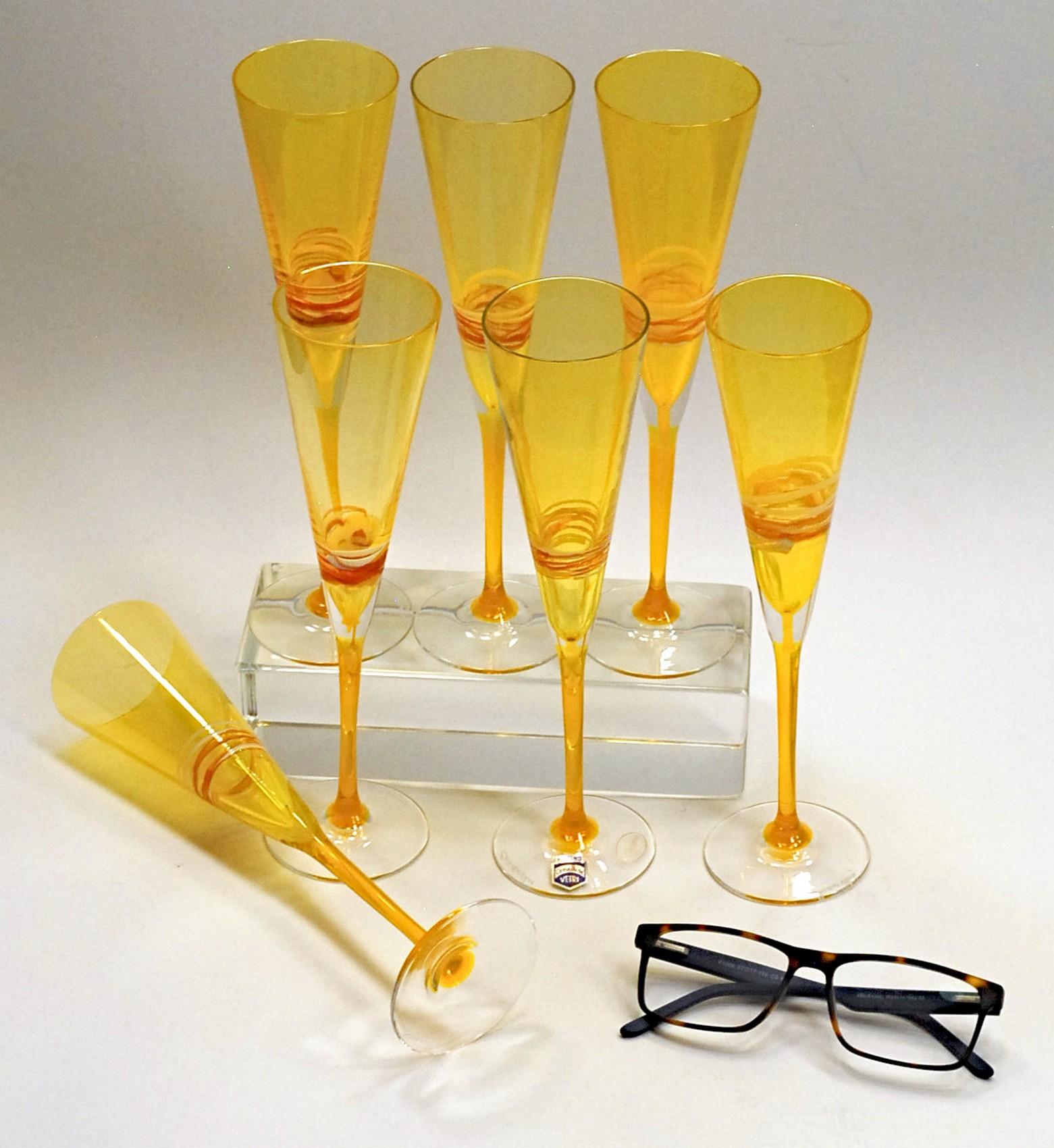 Set of six flutes from Cenedese, made in Murano at Cenedese factory.
All in the color that has been a signature of Cenedese, uranium yellow.
Each flute has a dripped red and white fili decoration. Typical of the young collection. 

Celebration