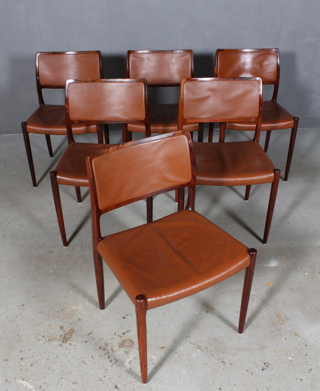 Set of six N. O. Møller dining chairs with frame of solid rosewood.

Seats original upholstered with brown leather.

Model 65, Made by J. L. Møller, Denmark, 1960s.