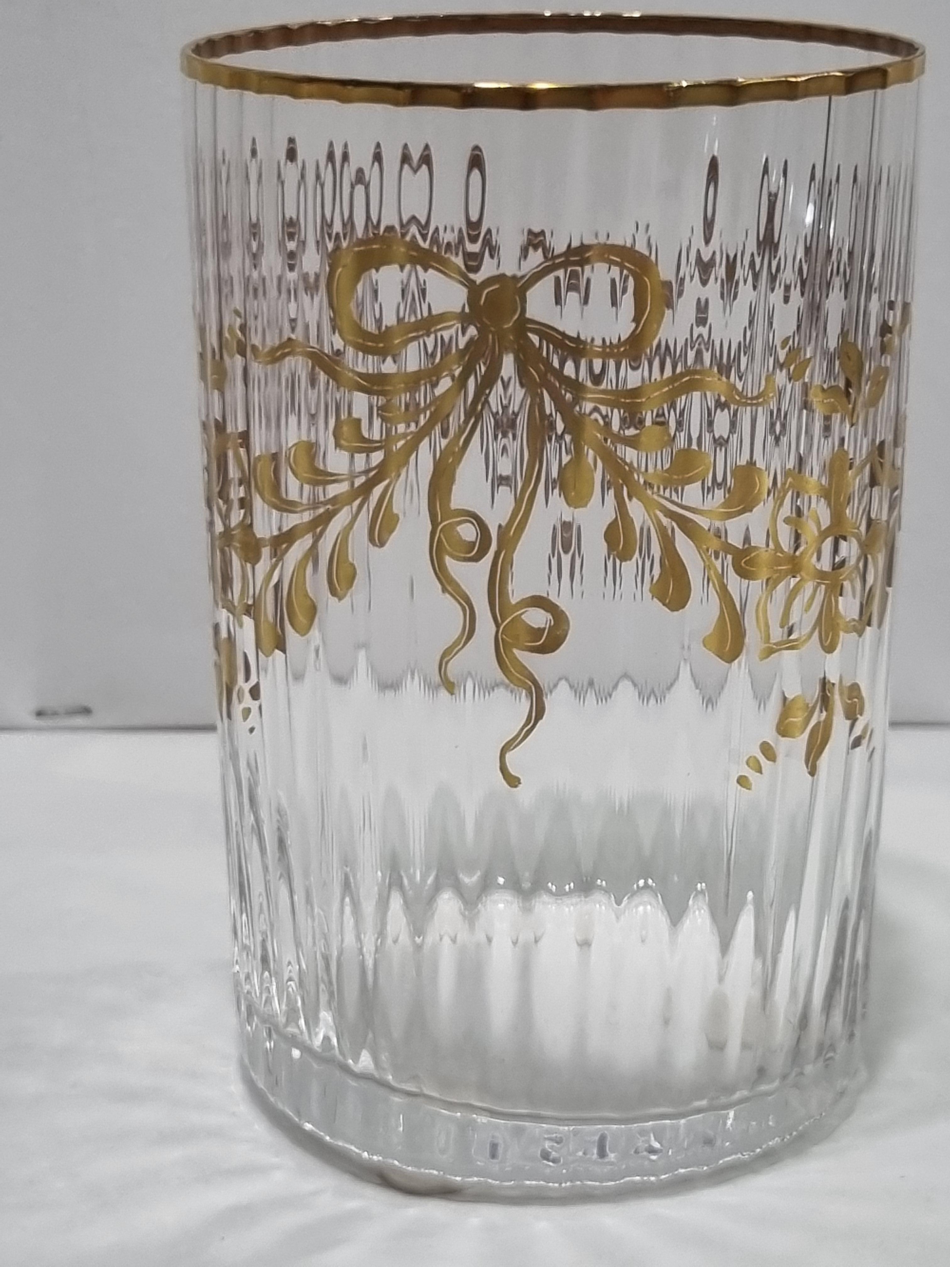 Extremely beautiful set of six tumblers in hand-blown and hand-painted Murano glass with gold motifs of bows and festoons, even the edge of the tumblers is in gold.
NasonMoretti, born in 1923, creates its products in a limited number, adressind