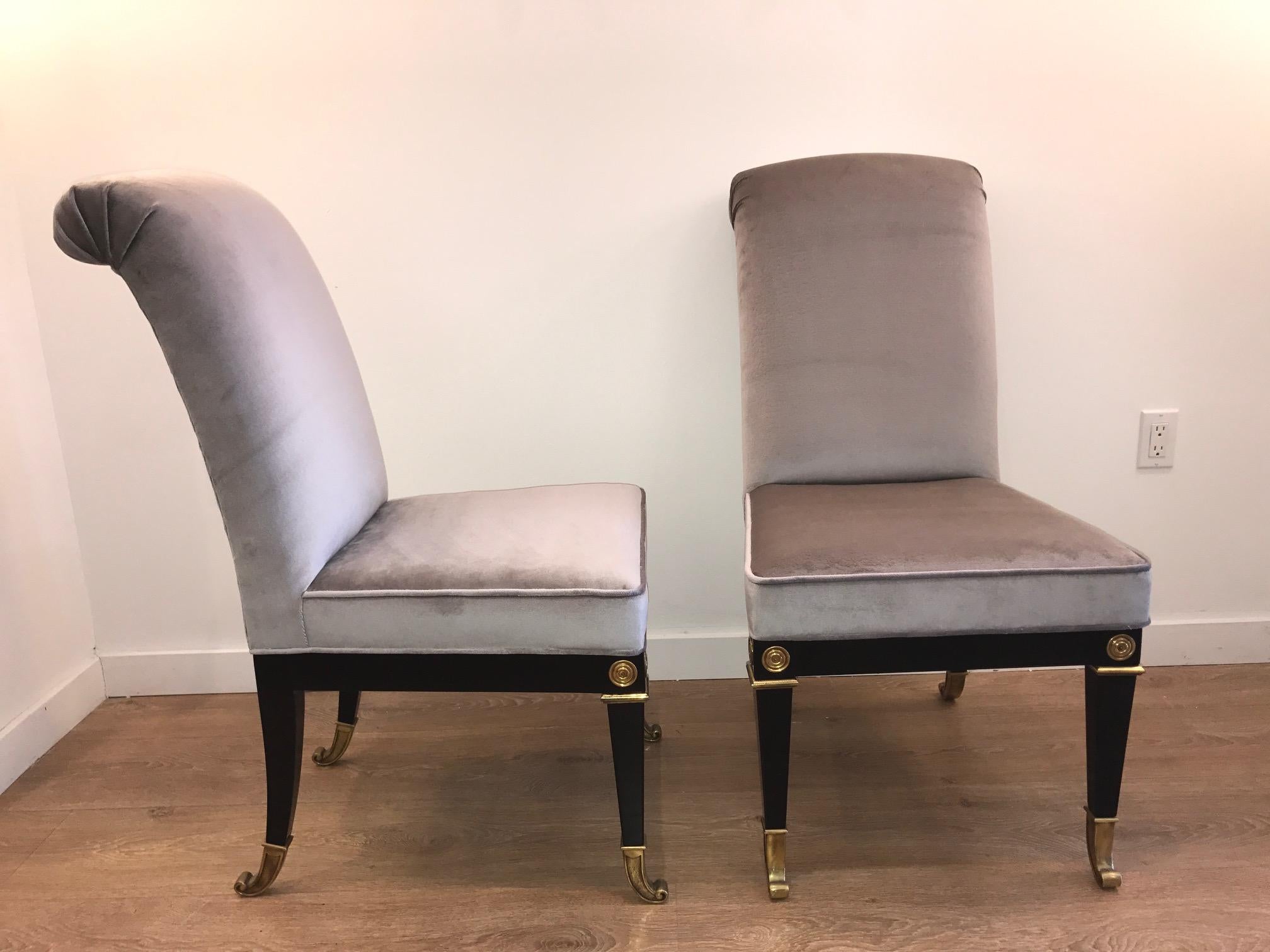 Set of six neoclassical dining room chairs by Mastercraft. Black lacquered saber legs terminating with bronze sabots. Chairs are newly restored and upholstered, bronze and brass elements where kept with original patina.

