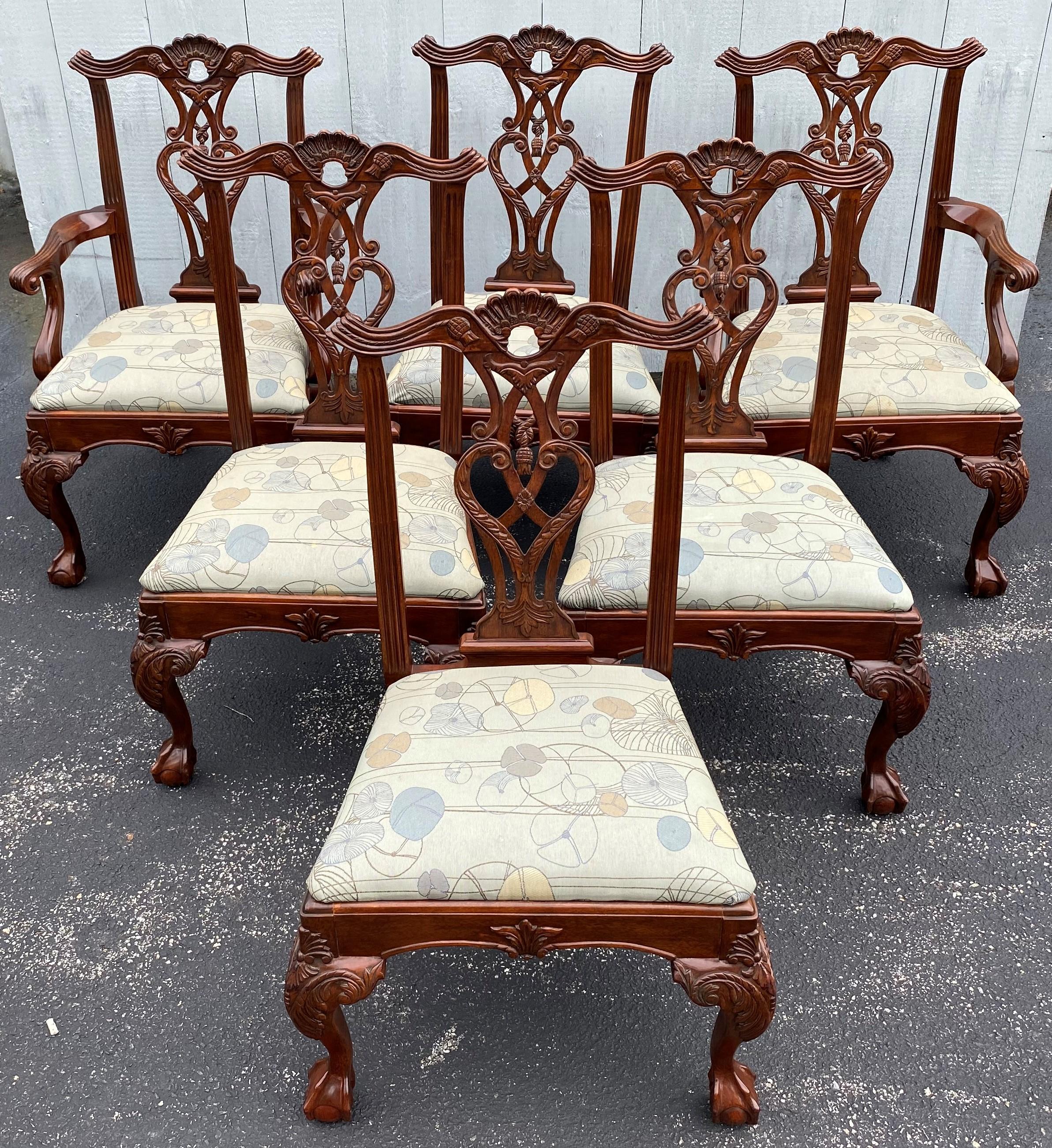 A fine set of six Chippendale style solid mahogany dining chairs including two arm chairs and four side chairs, each with nicely pierce carved shell crests and splats, scroll & foliate carved skirts & front cabriole legs, terminating with ball and