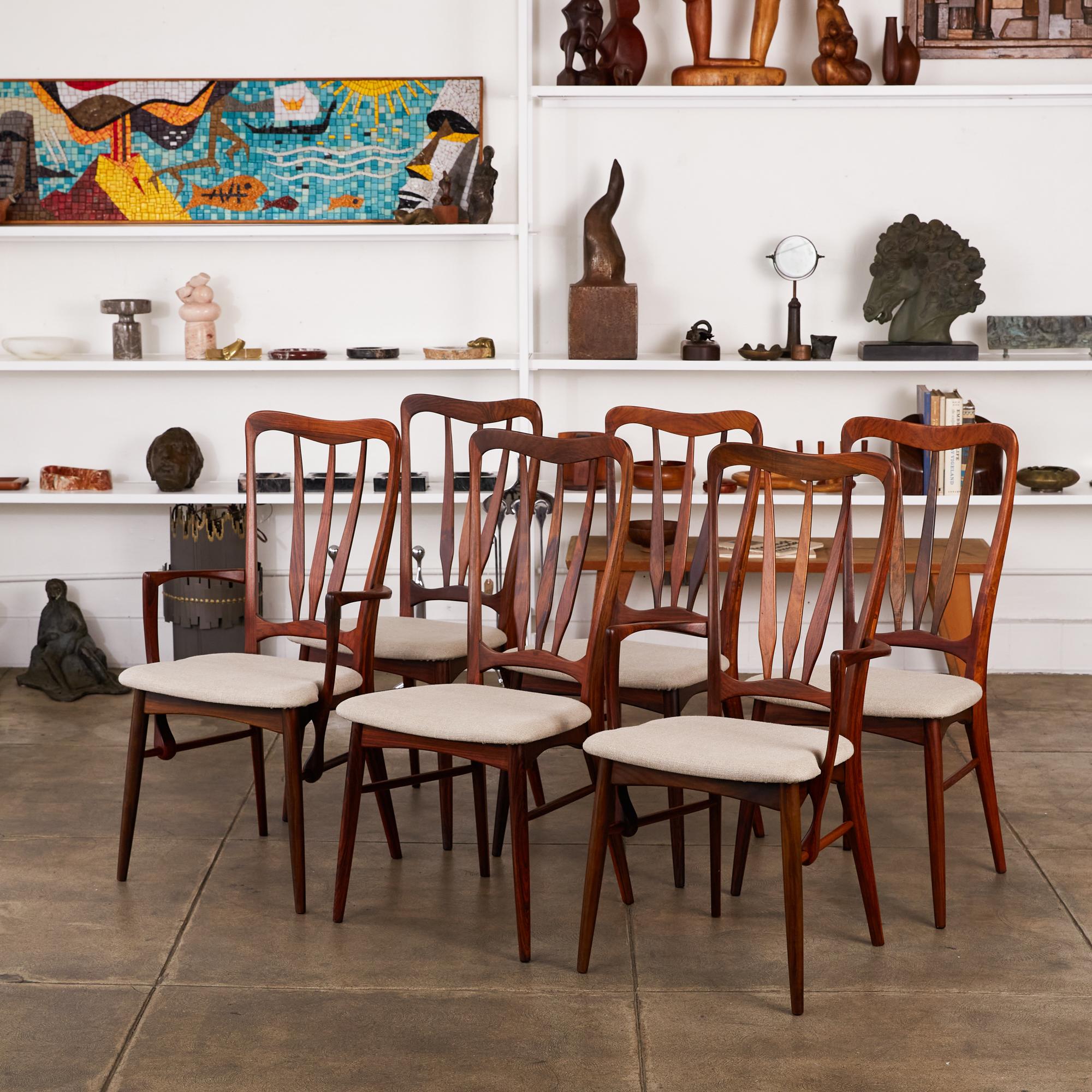 Set of six Niels Koefoed “Ingrid” dining chairs in rosewood, Denmark, circa 1960s. The set of four side chairs and two armchairs feature sculpted rosewood frames with new linen upholstery. The armchairs have a signature detail where the vertical