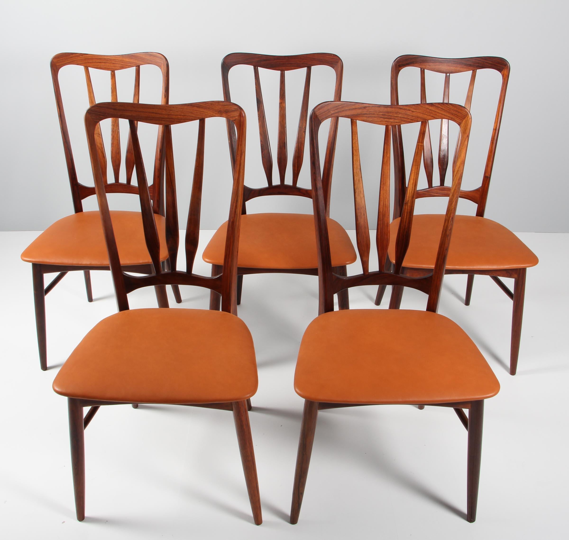 Set of five Niels Koefoed dining chairs in rosewood.

New upholstered with cognac aniline leather.

Made by Koefoeds Møbelfabrik.