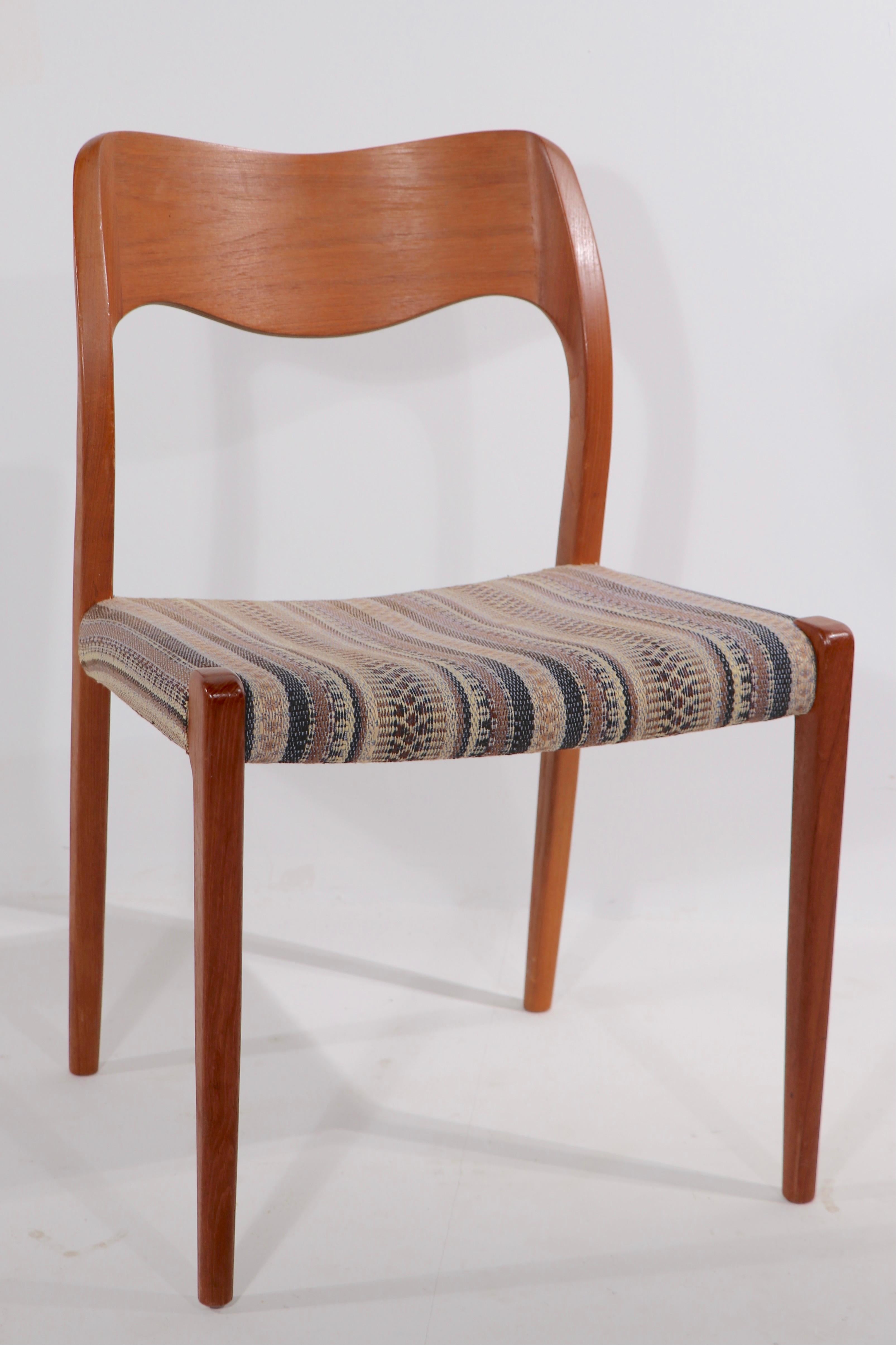 Original clean set of Niels Moller design model 71 dining chairs made by J.L. Mollers. This set is of solid teak, with fabric upholstered seats. All are in very fine, ready to use condition, one seat has inconsequential wear to the fabric - please