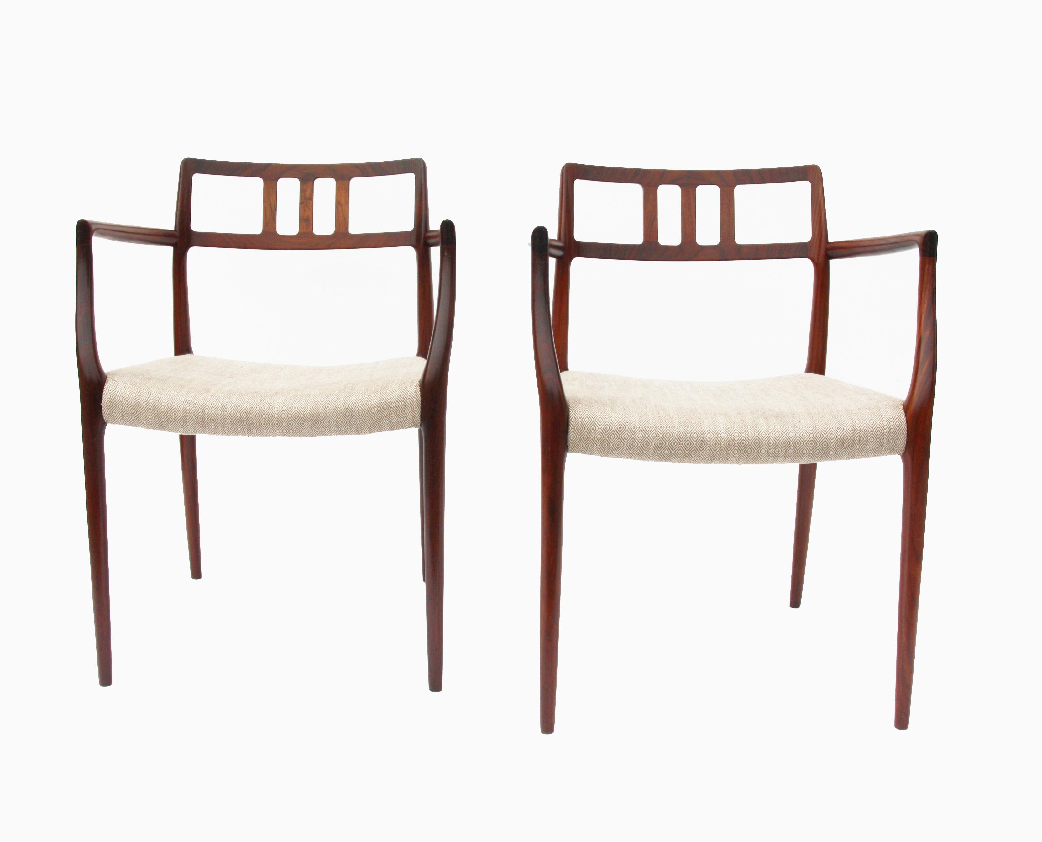 Vintage set of six dining chairs designed by Niels O. Møller. Stamped under each seat. The set includes two captain armchairs and four side chairs.