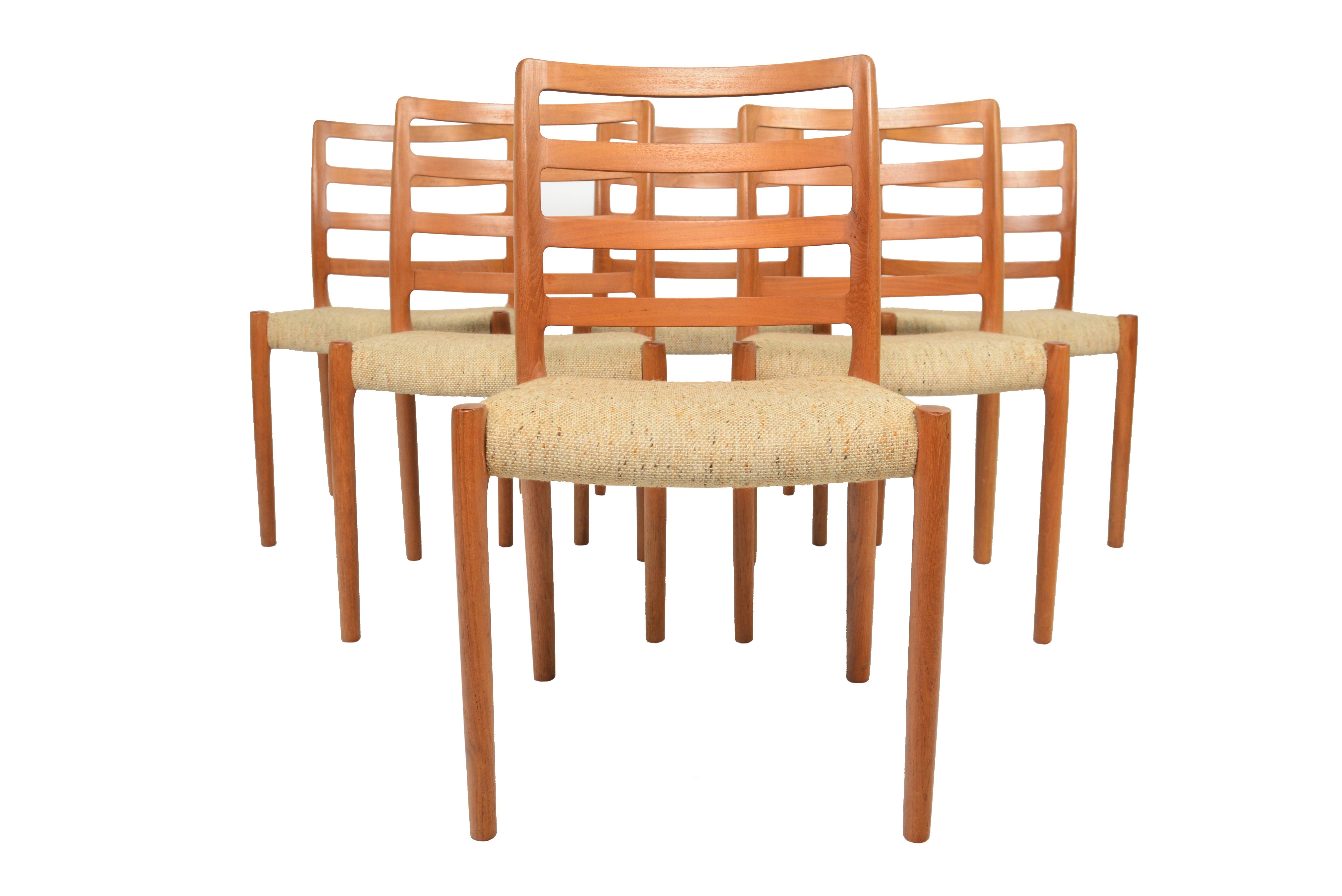 This beautiful set of six Model 85 teak dining chairs was designed by Niels Otto Møller for J.L. Møllers Møbelfabrik in 1981. Crafted in teak these chairs were designed with a focus on ergonomics and seamless construction. Seats wear their original