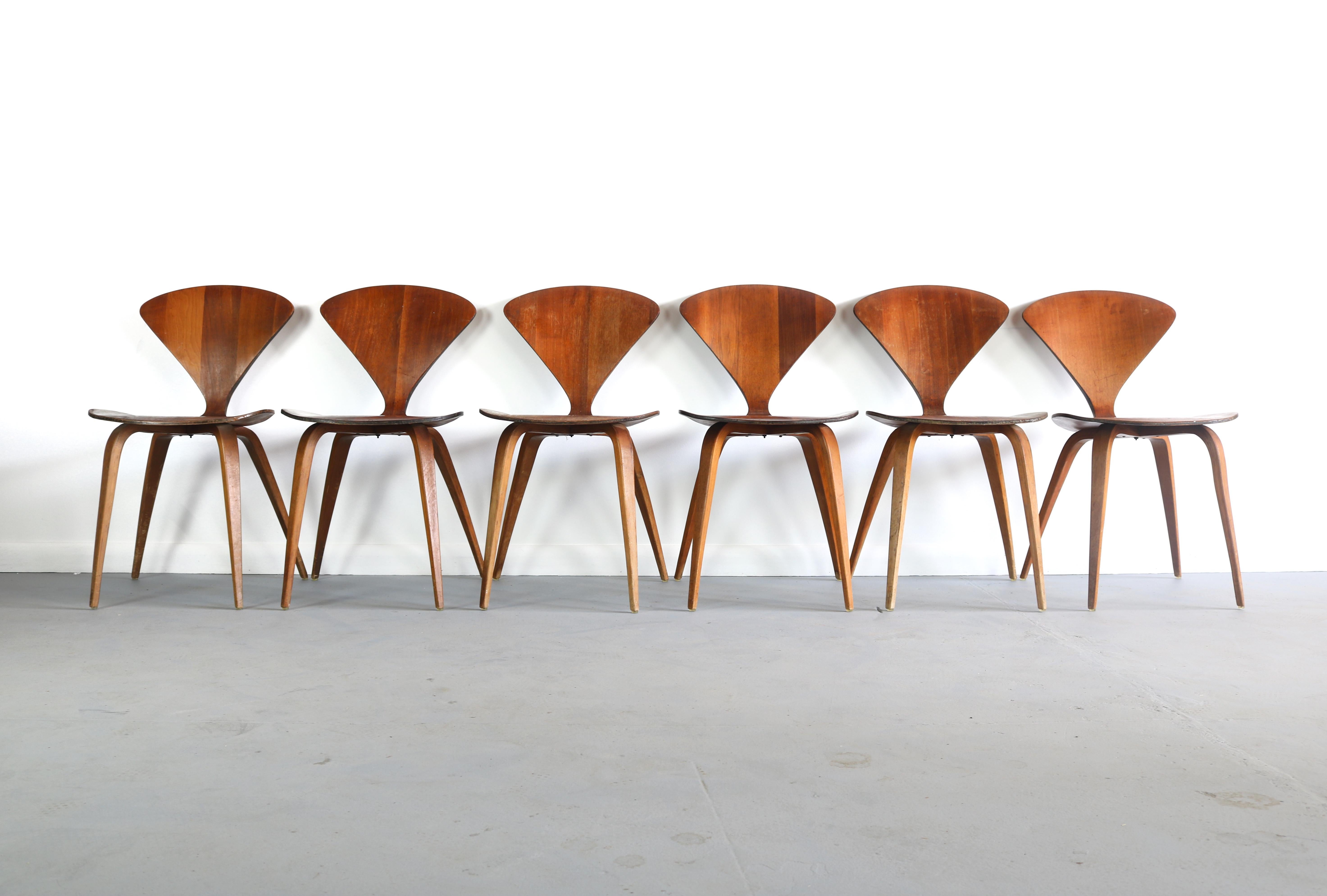 A set of six original Norman Cherner Pretzel dining chairs, made by Plycraft, USA in the 1960s. Bentwood frames. In good vintage condition. Plycraft labels to the underside of some examples.


  