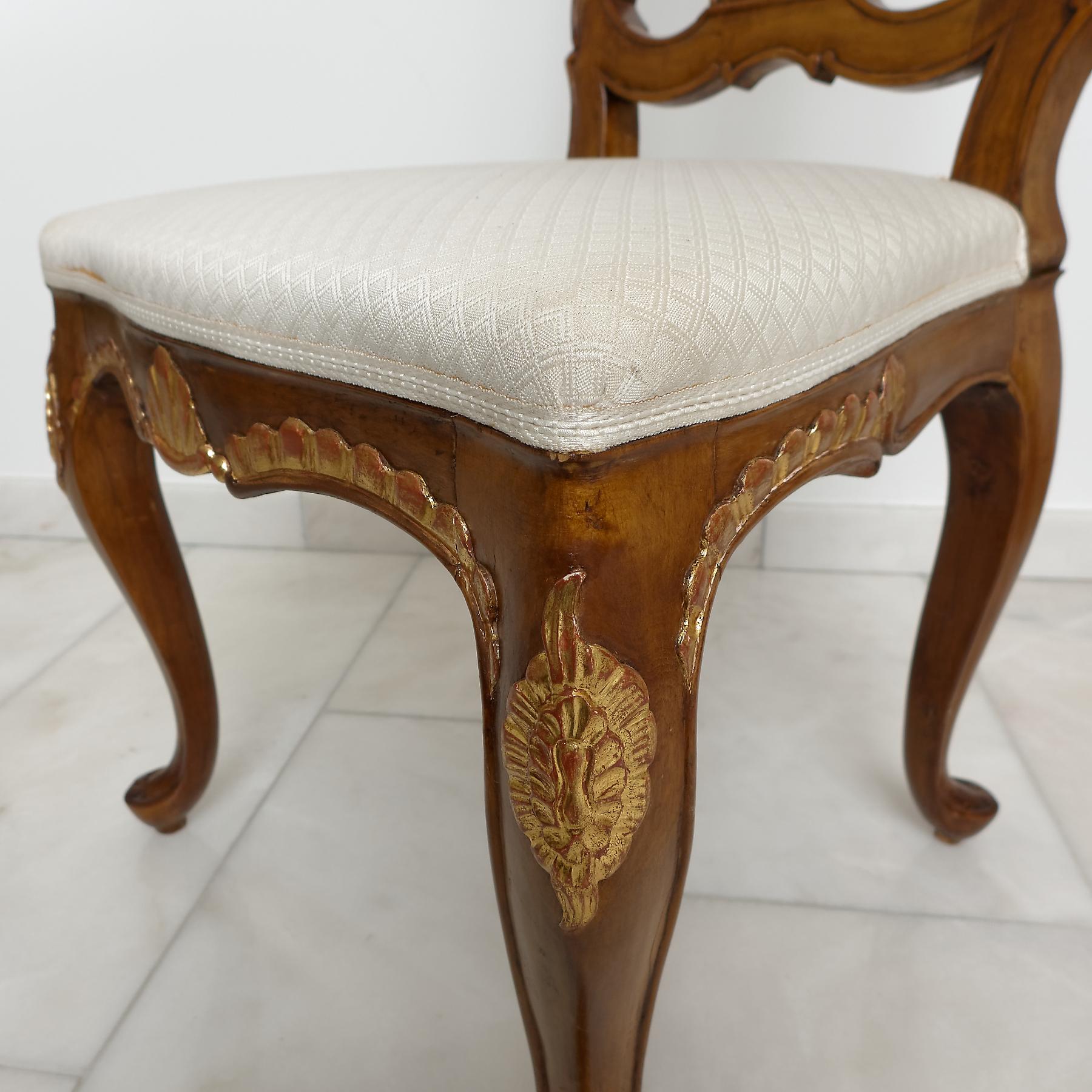 A set of six North European (Danish or North Germany) parcel-gilt beechwood dining chairs. The pierced back with shaped splat, above a bow-fronted padded seat, on cabriole legs. Seat rail, legs and top of the back with decorative foliage parcel gilt
