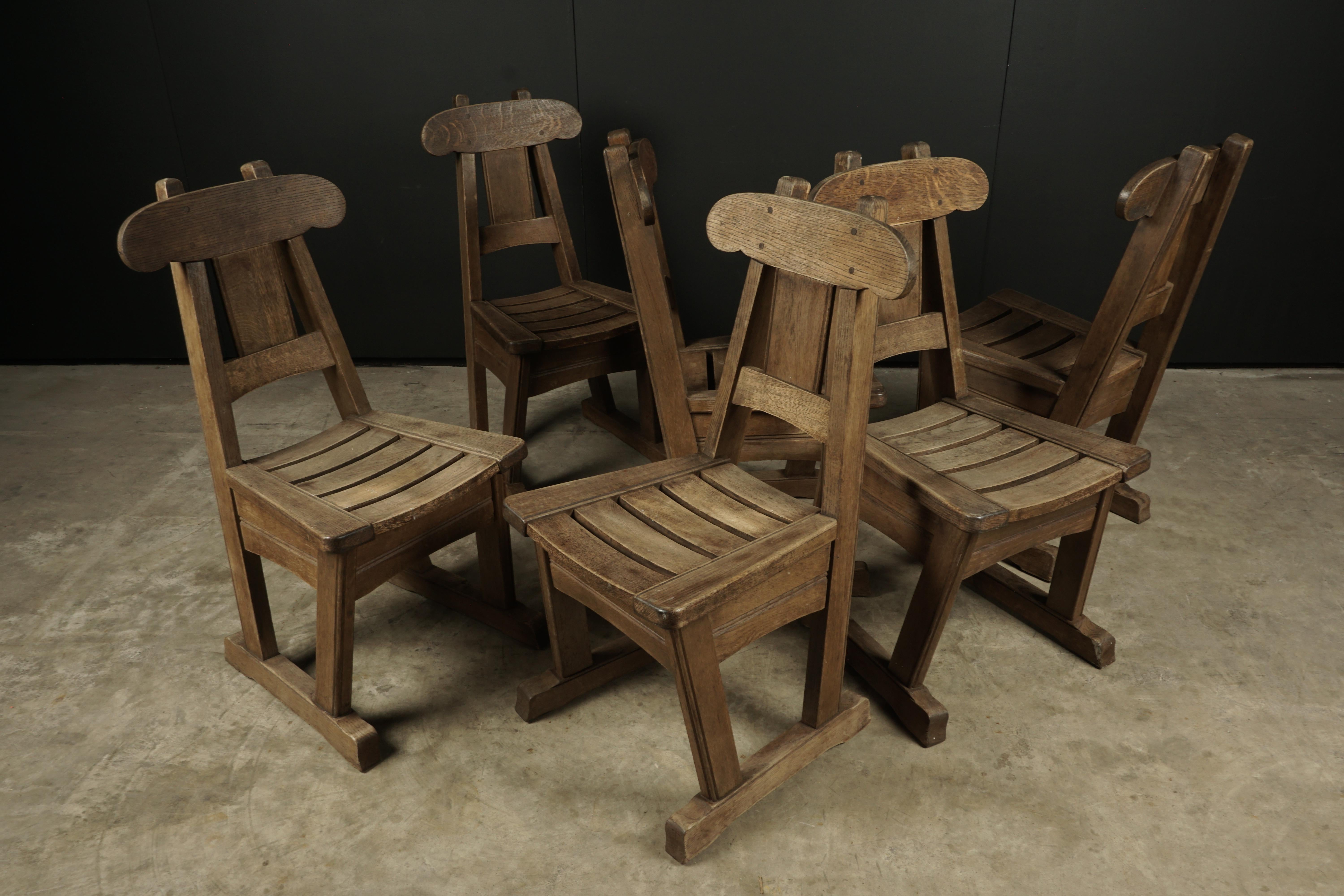 Vintage set of six oak Brutalist dining chairs in oak, from Holland, circa 1960. Solid oak construction with light wear and patina.