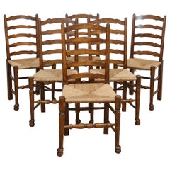 Set of six oak ladder back dining chairs