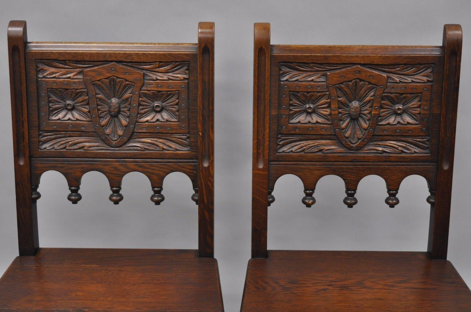 Set of six Antique oak wood gothic/renaissance revival dining side chairs. Item features solid wood construction, beautiful wood-grain, nicely carved details, stretcher bases, floral & leaf carved backs. Circa Early 1900s. Measurements: 35