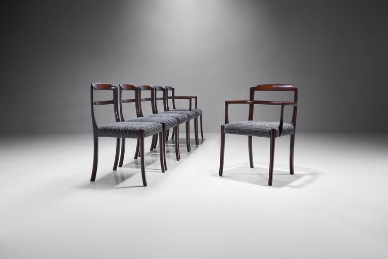 This set of dining chairs by Danish designer Ole Wanscher features distinctive splayed legs and fine exposed joinery in the back. The design is honest and simple with a refined technique and materials which makes this set a true example of