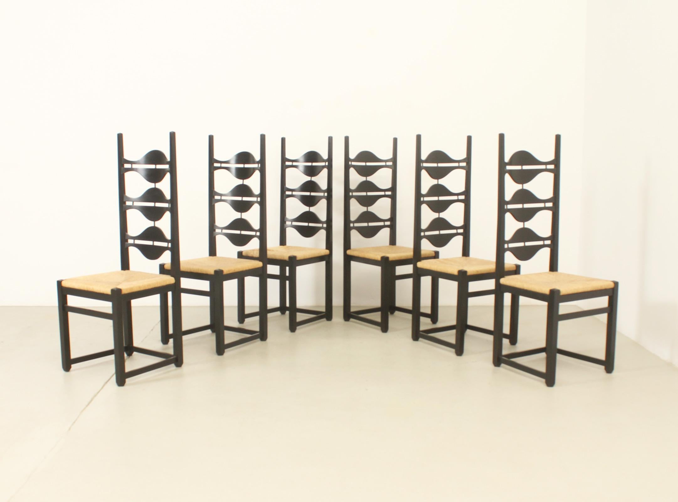 Set of six Olot dining chairs designed in 1962 by Jordi Vilanova, Spain. Solid ash wood with black lacquer and woven rush seats. Modern reinterpretation of Spanish chairs from the Mediterranean area.