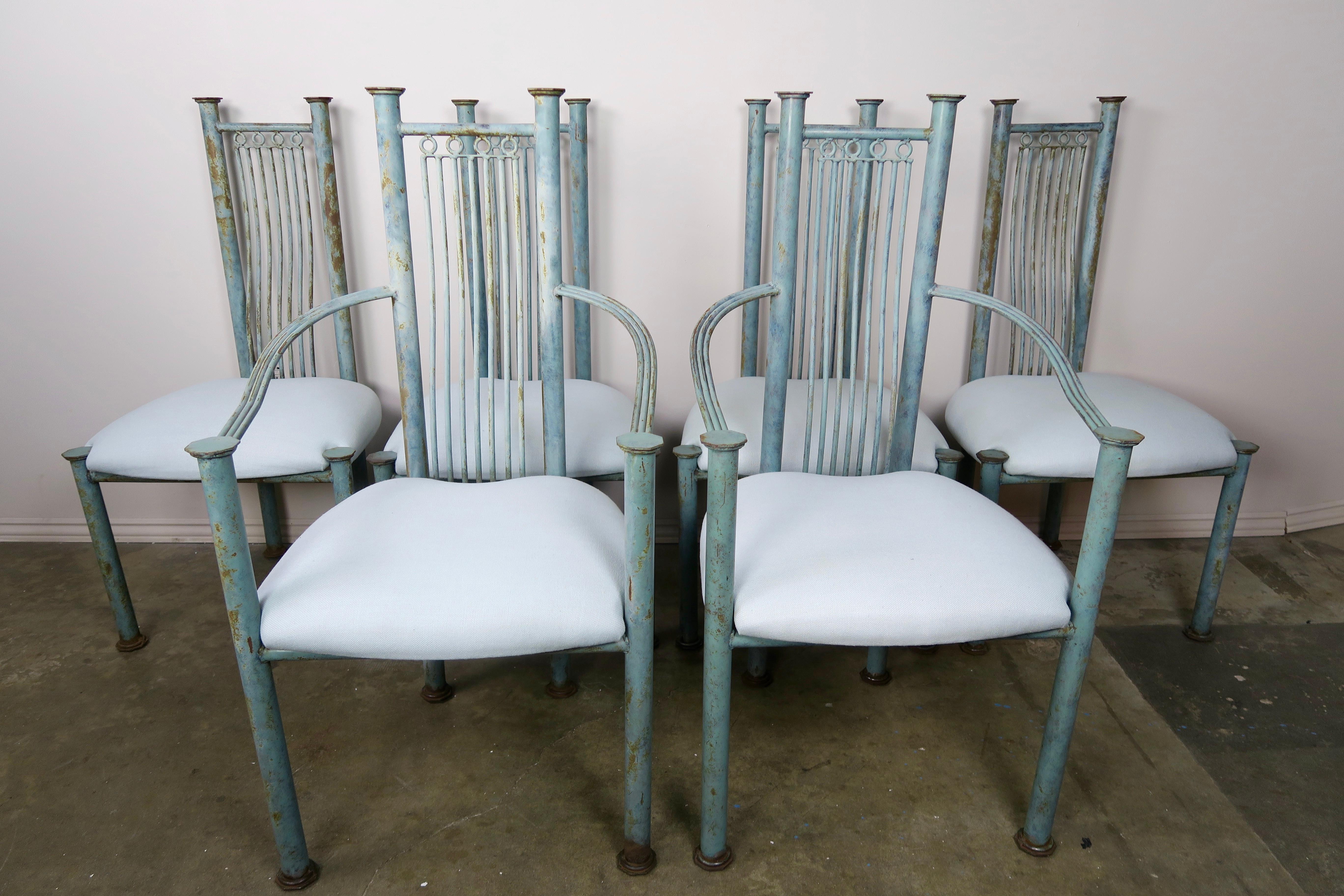 Set of six Italian dining chairs, (2) armchairs & (4) side chairs from the mid-20th century. The chairs are painted in a soft robin's egg blue with soft brown accents (worn paint). The chairs are newly upholstered in a soft blue colored linen that
