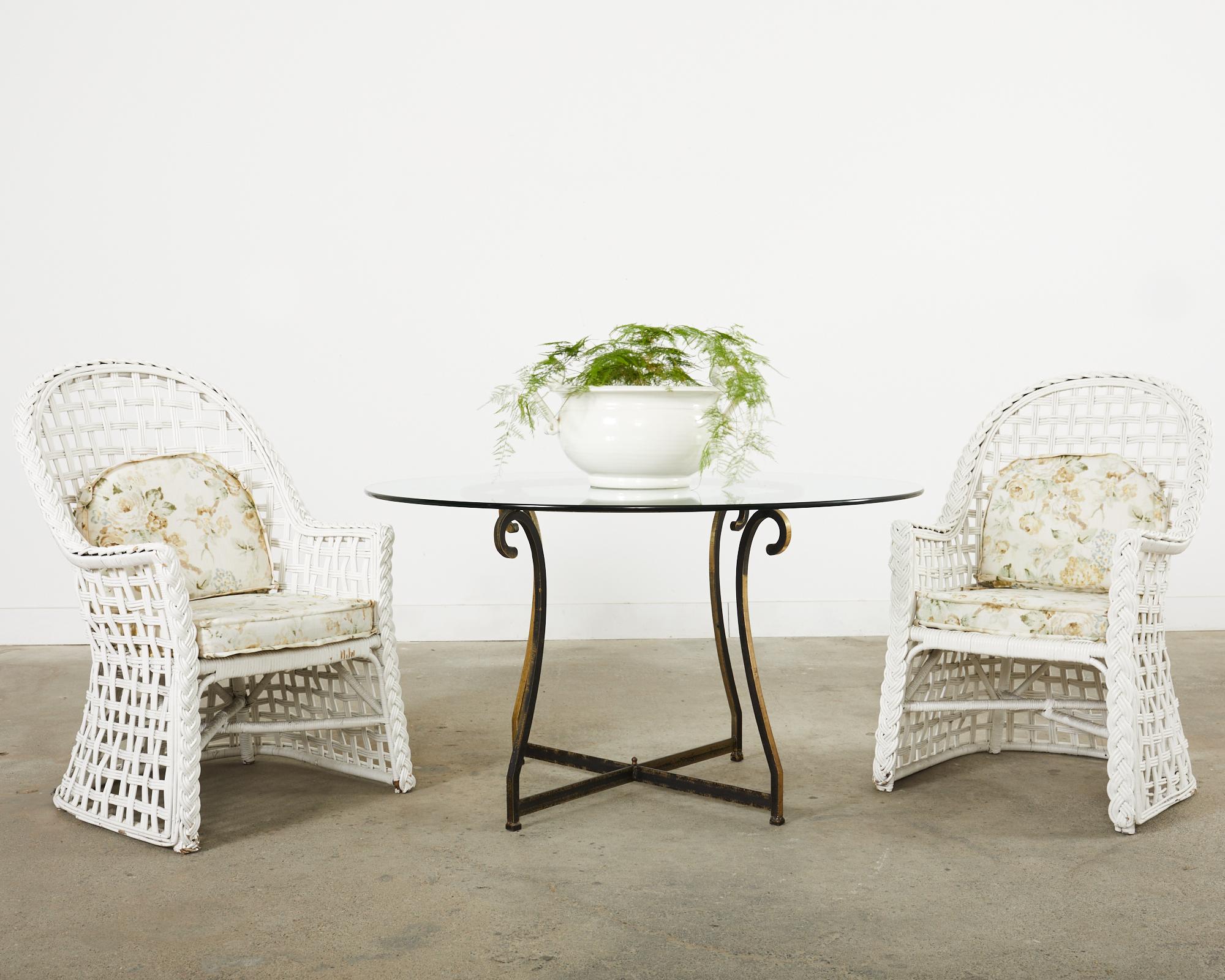 Mid-century modern set of six rattan garden dining armchairs made in the California coastal organic modern style featuring a vintage painted finish. Beautifully crafted with large high back rattan frames decorated with pencil reed lattice wicker in