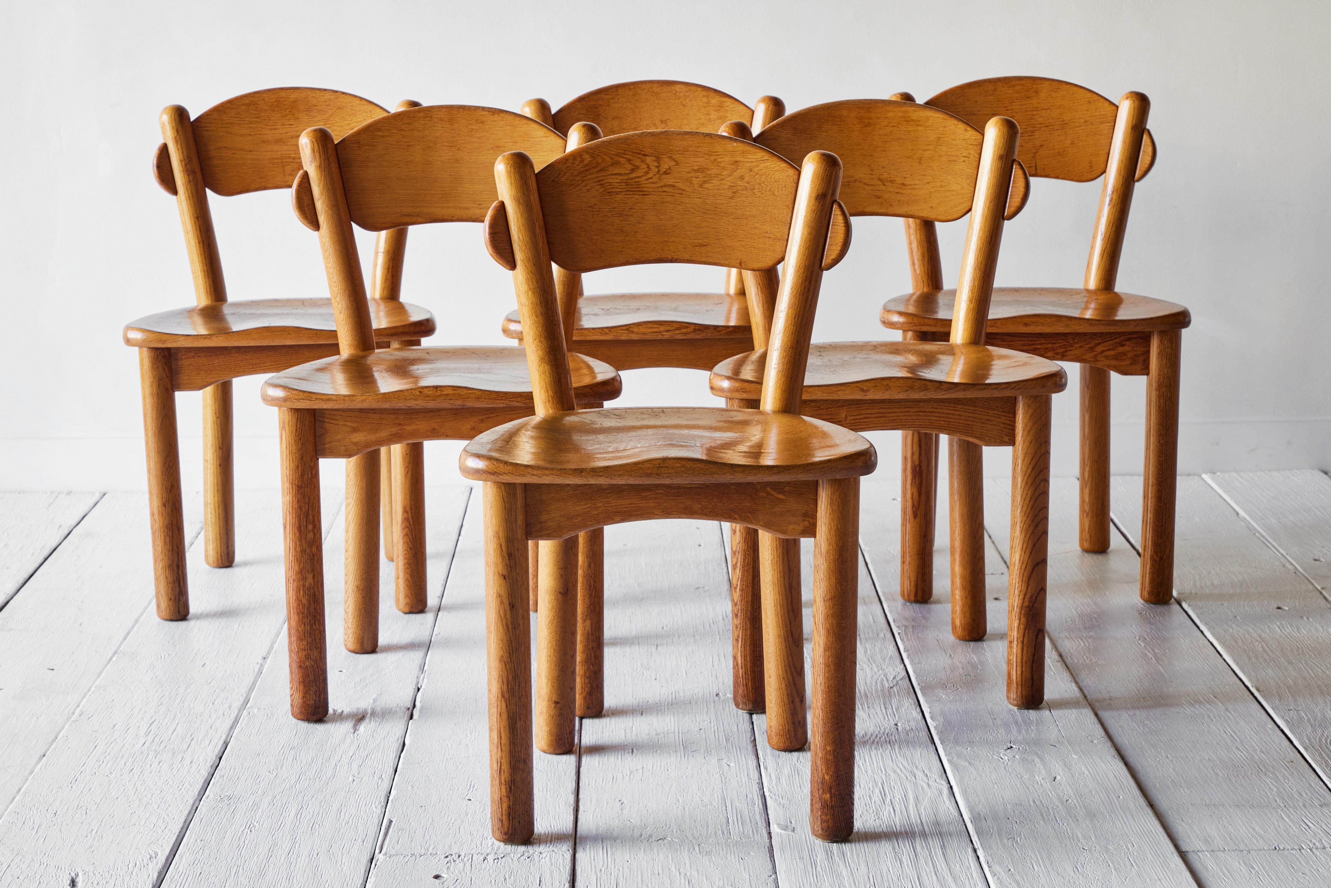 Set of six solid pine wood chairs designed by Rainer Daumiller and manufactured by Hirtshals Savvaerk in the 1970s. The chairs have a carved seat and backrest which give them a robust and organic appearance.The rustic pine wood boasts a rich and