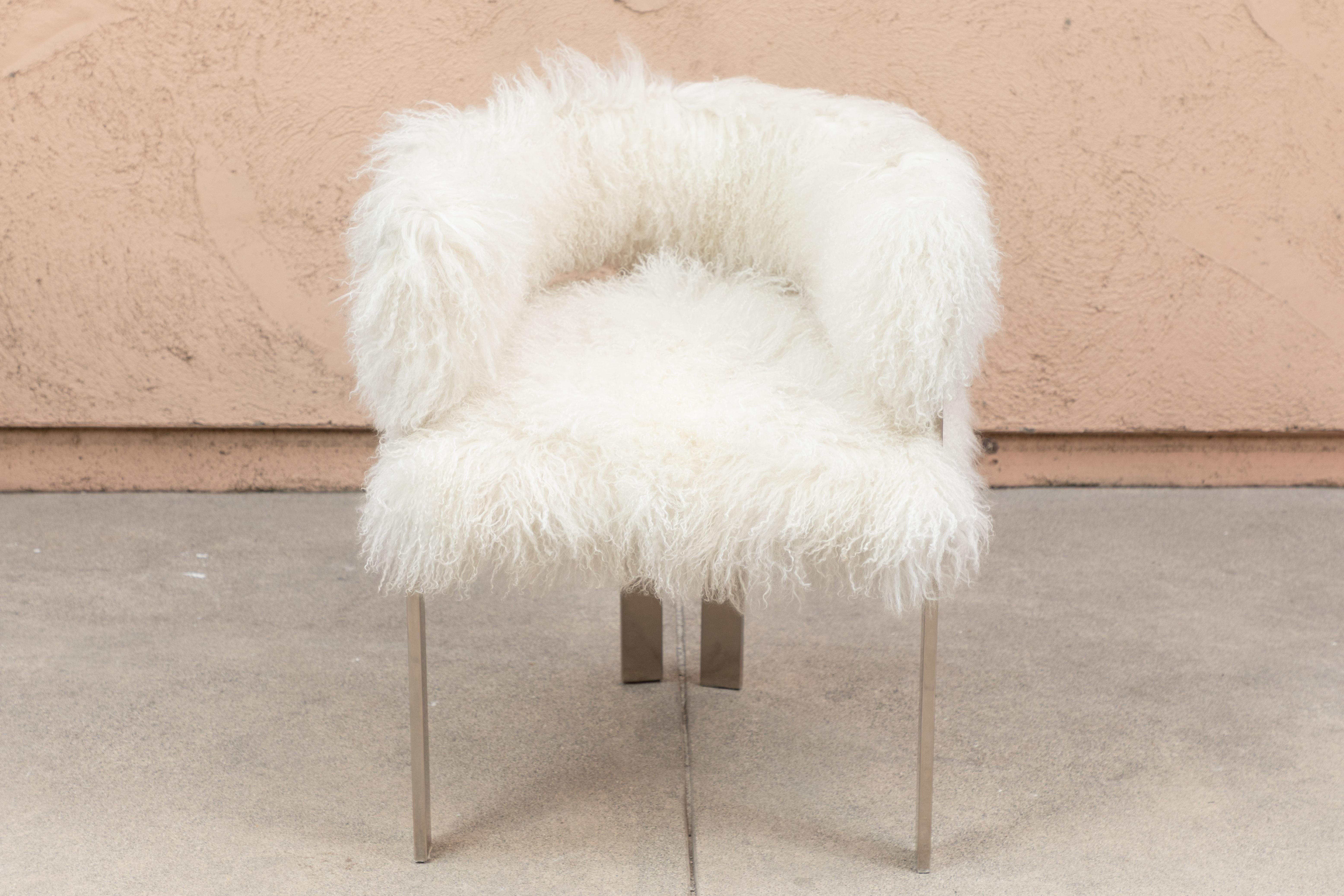Contemporary set of dining chairs in polished nickel frames and upholstered in white Mongolian lamb fur.
