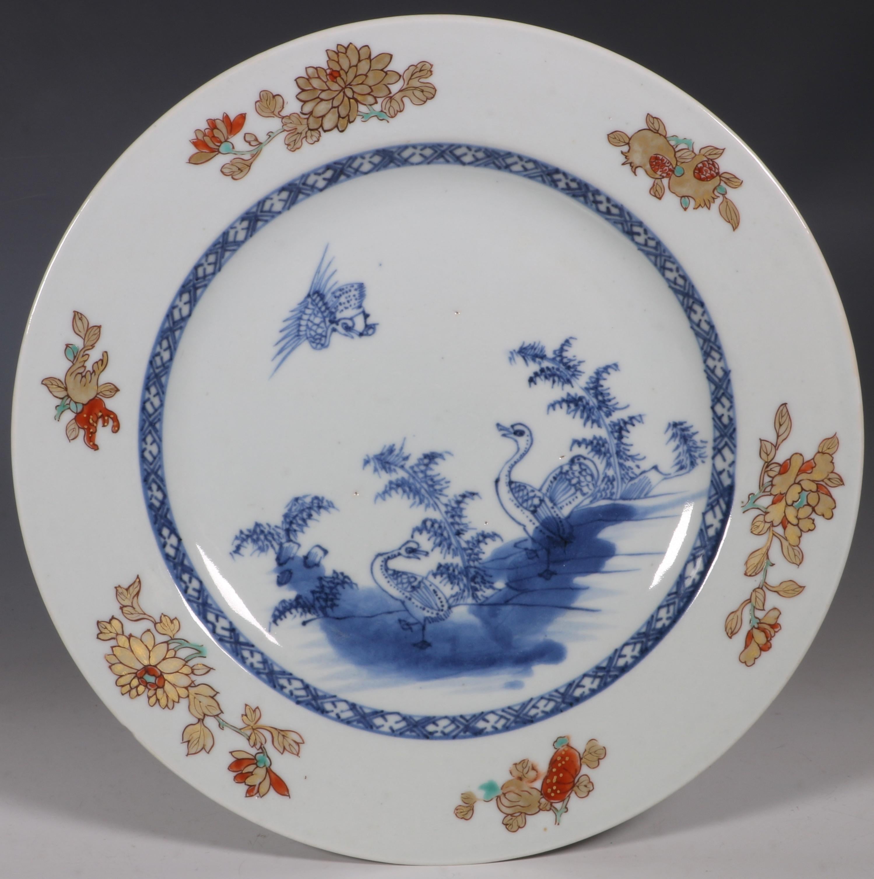 A set of six export plates. Each decorated in the centre with three geese on rocks with another in flight in underglaze blue. The rim with chrysanthemum, carnation, peony, pomegranate, melon and finger citron in iron red, gilding and green enamels.