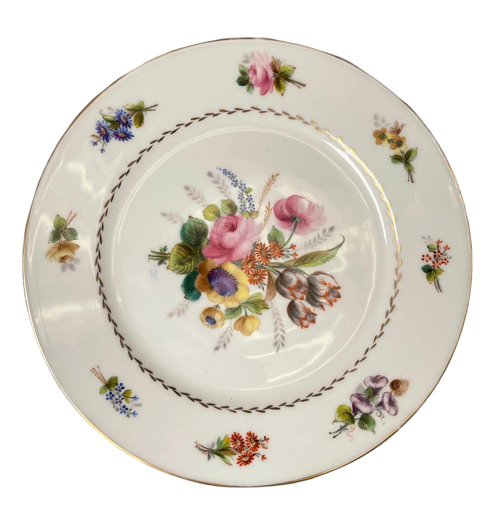 This is a set of six lunch or dessert porcelain plates from the Collection of the Manoir Montsalvy. They belong to the collections #2, 6, 7, 10, 11 and 12. They are hand painted with bouquets of flowers in the center and tiny bouquets around the
