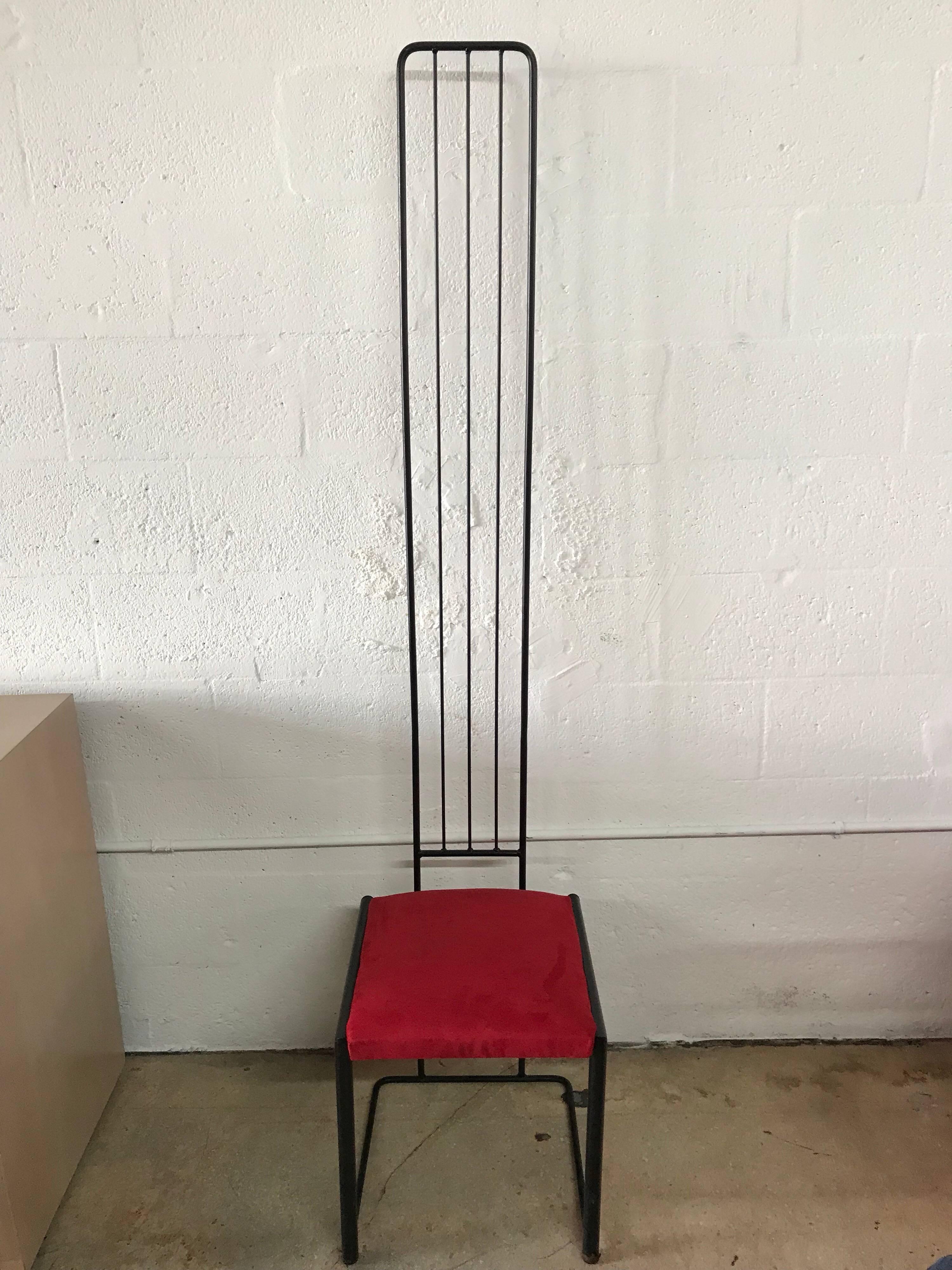 Six Postmodern dining chairs with exaggerated tall backs rendered in black powder coated aluminum and red seats.

Measures: seat height 17.5