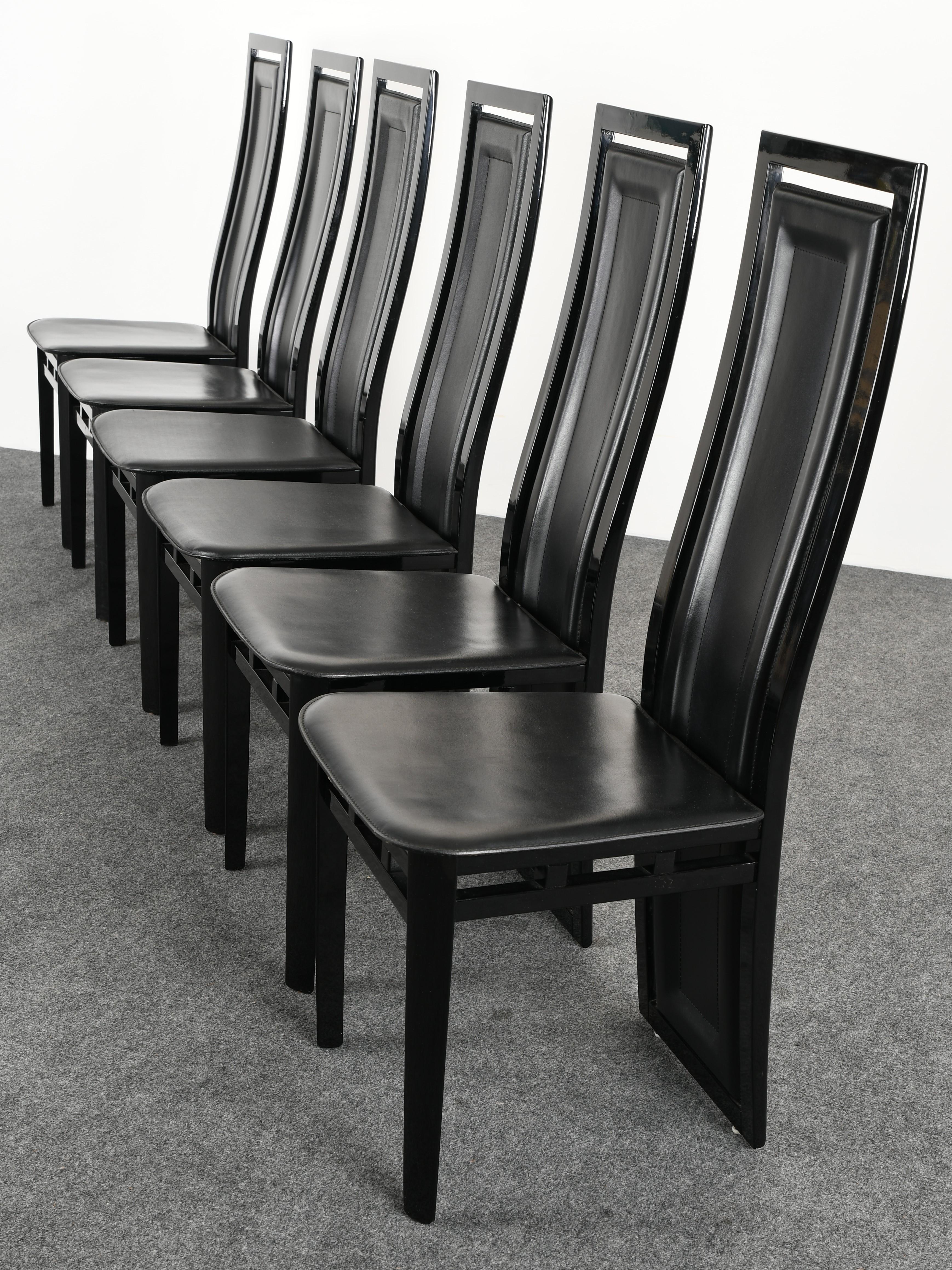 A set of six Postmodern contemporary style Italian Sibau dining chairs made of ebony lacquered wood and black leather seats.

Dimensions: 43.25