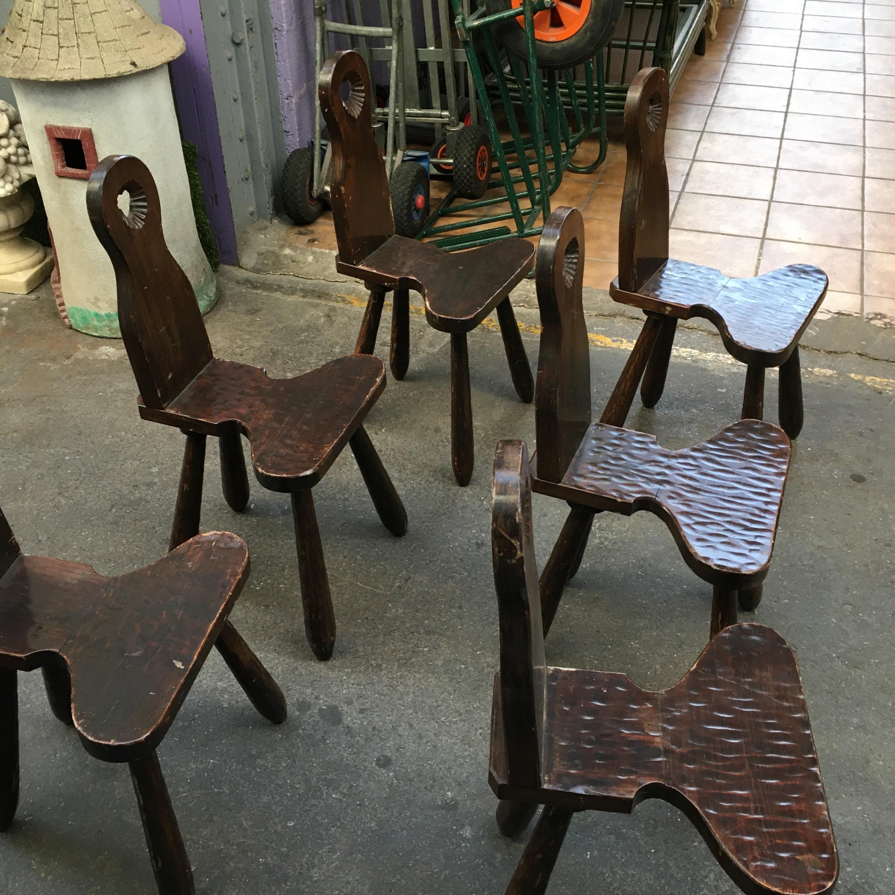 A set of six carved solid oak chairs attributed to Jean Touret