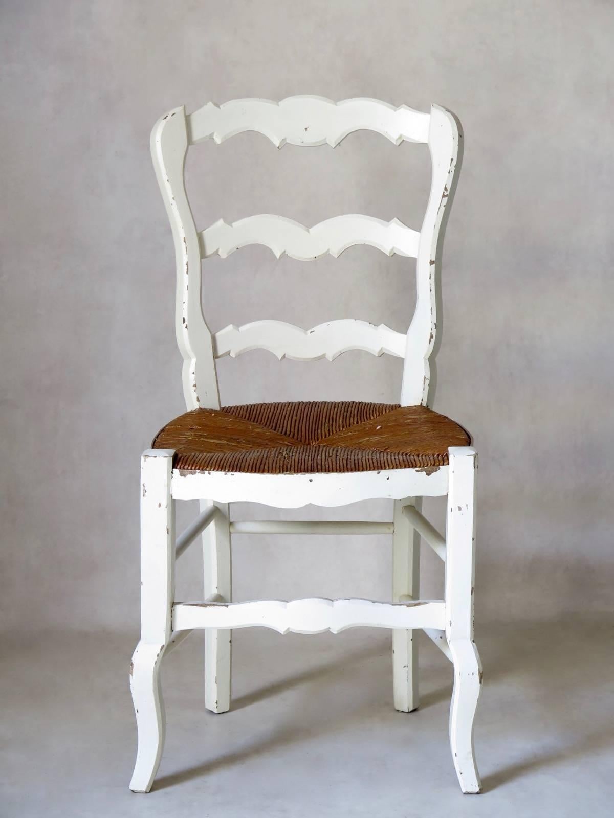 Charming set of six rustic, Provençal dining chairs of painted beechwood, with rush seats.