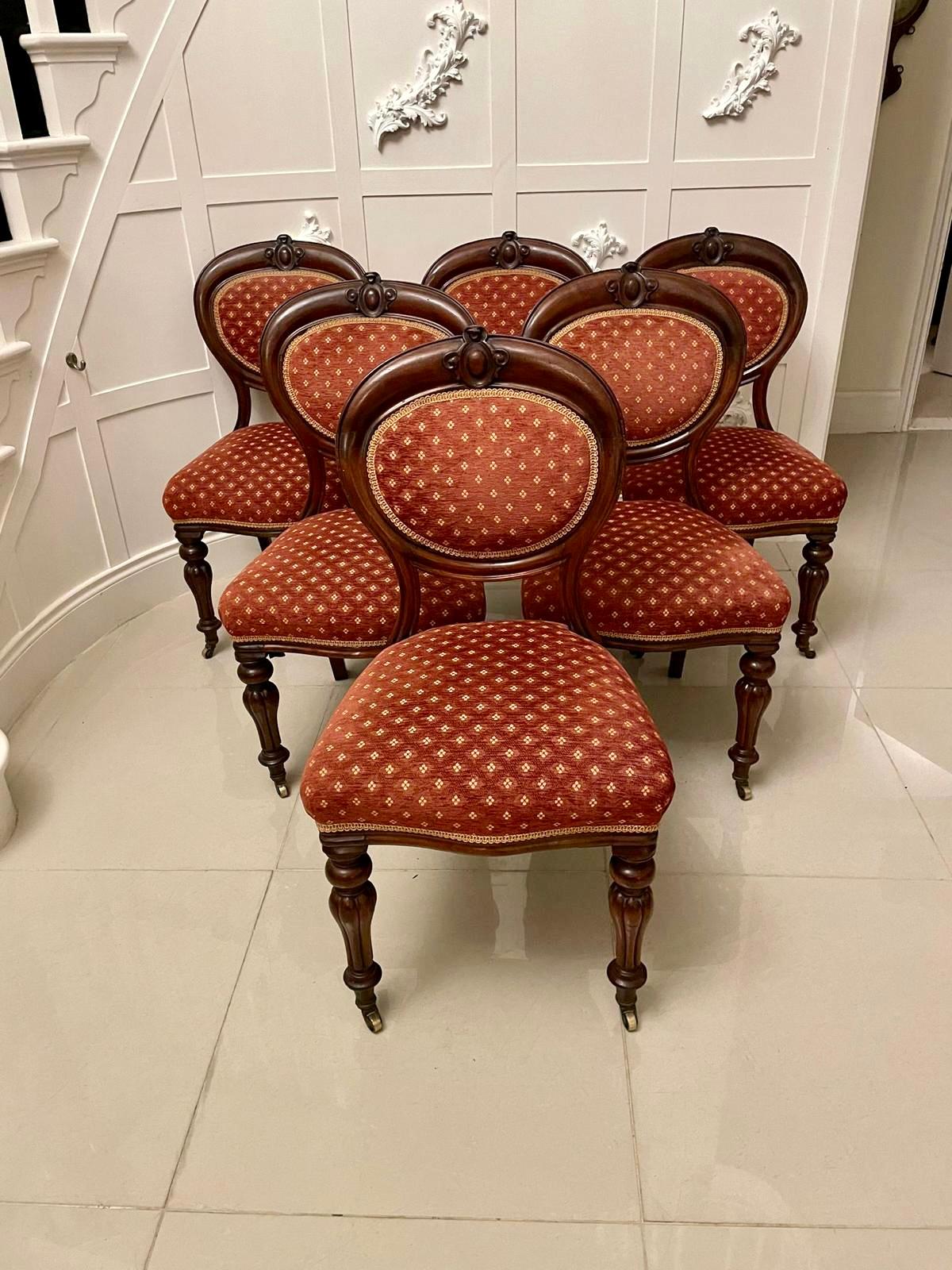 Set of six quality antique Victorian mahogany dining chairs having a quality mahogany balloon back with a carved top standing on attractive shaped reeded turned legs with original brass cup castors.

We are able to offer a re-upholstery service on