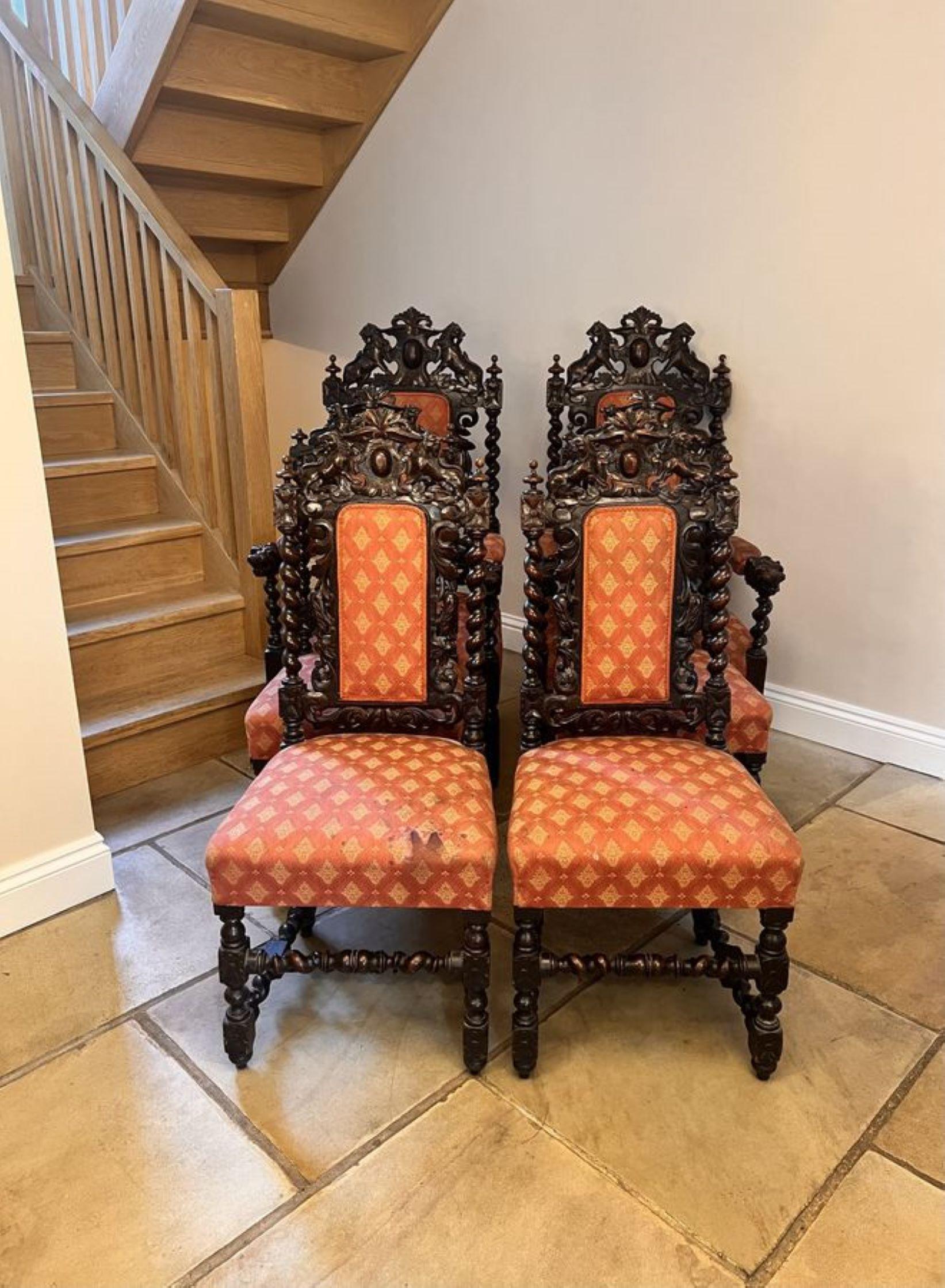 Set of six quality carved oak antique Victorian dining chairs, consisting of a pair of arm chairs and four sides chairs, having quality carved oak backs with carved lions to the top, barley twist supports carved scrolls upholstered panel backs and