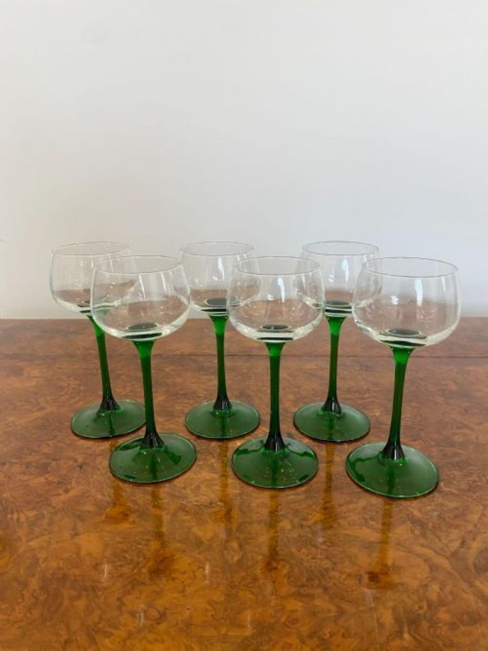 Set of six quality Edwardian wine glasses with green stems on a circular base 
