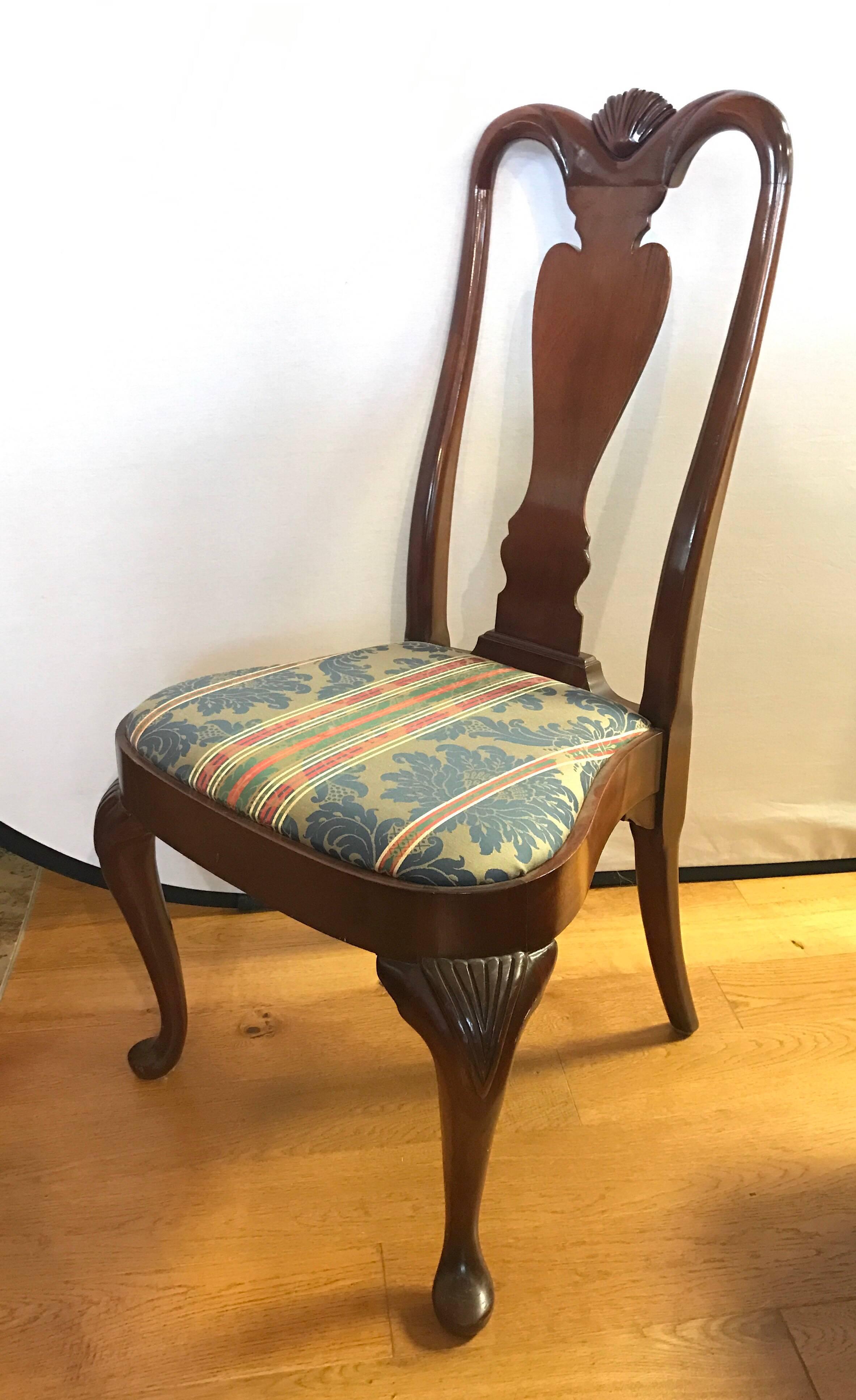 Set of six Queen Anne mahogany dining chairs with carved scallop shell detail at top. Drop in seats are upholstered in a luxurious red and blue striped damask fabric.