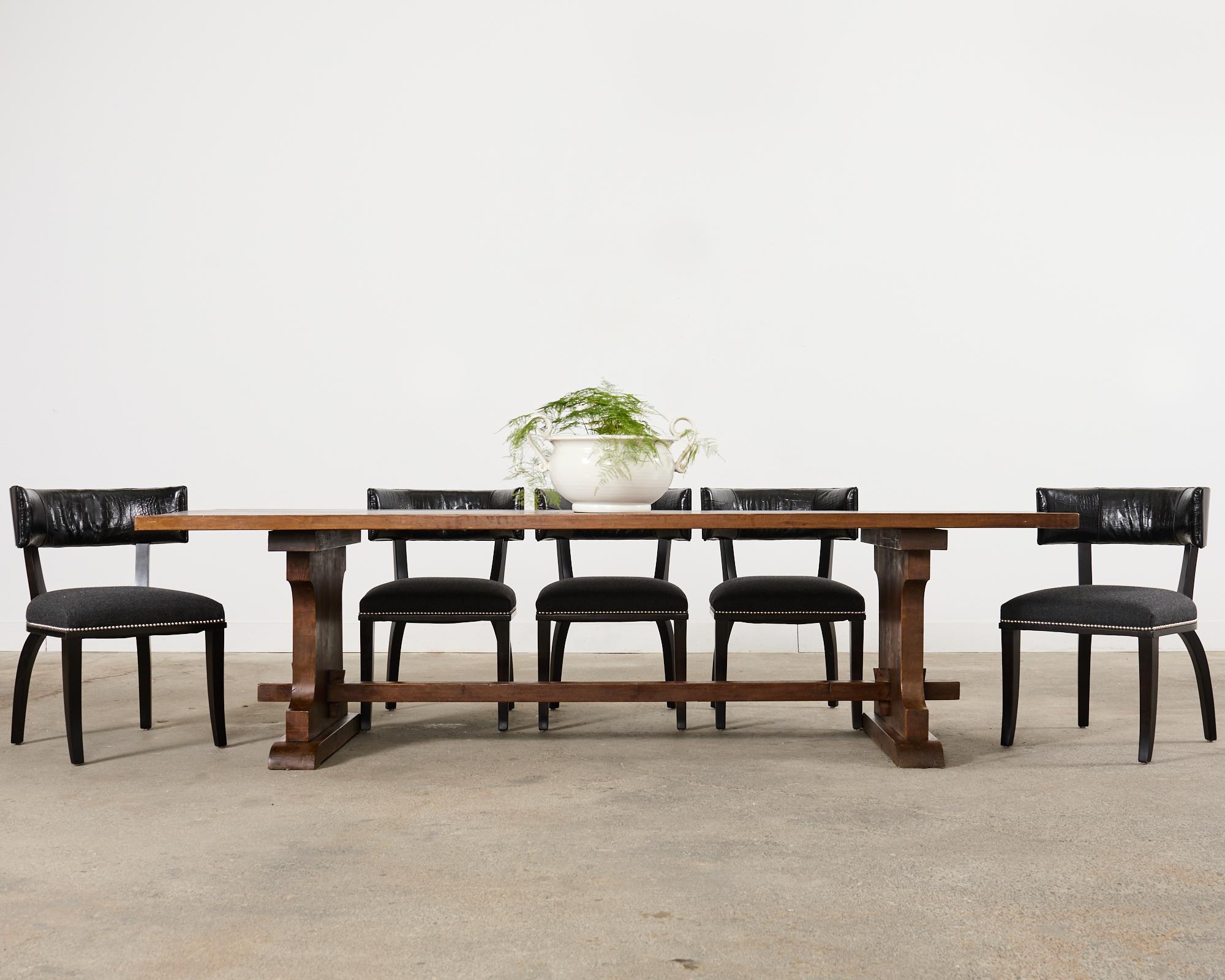 Dramatic set of six neoclassical style clivedon dining chairs designed by Ralph Lauren. The bench-made bespoke chairs feature a klismos style beech frame with rich faux macassar ebony veneered backrests. The front of the rest features a black