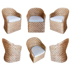 Juego de seis sillones de ratán con cojines