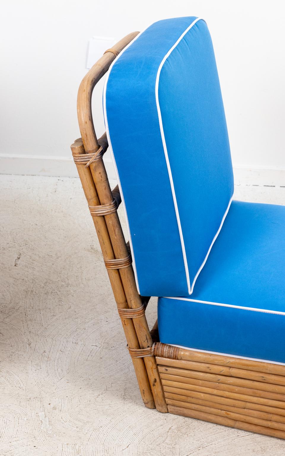 Set of six Mid-Century Modern style rattan chairs, newly upholstered in blue with cord trim. Please note of wear consistent with age including minor finish loss to the rattan.