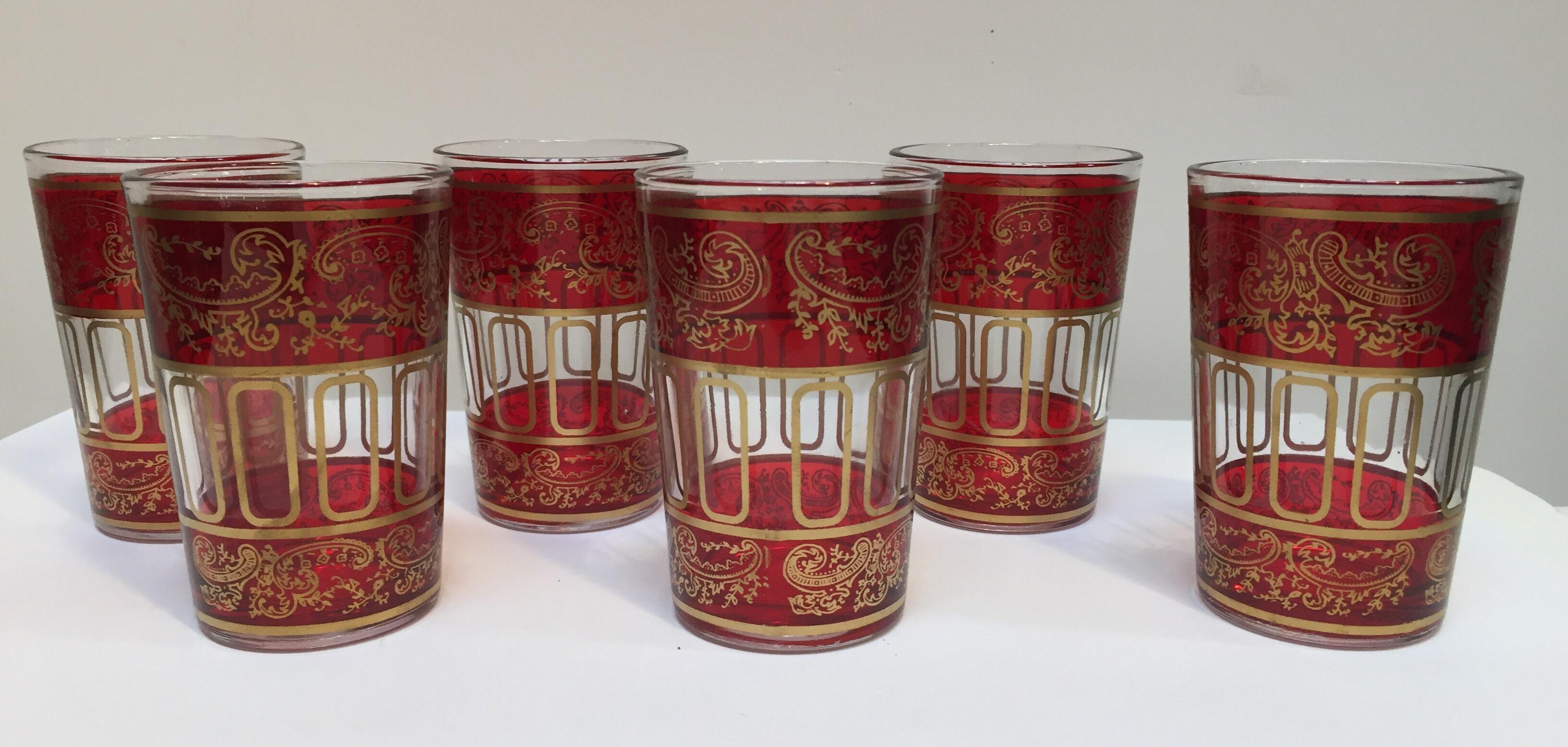 Set of six red glasses with gold raised Moorish design.
Decorated with a classical gold and pattern Moorish frieze. 
Use these elegant glasses for Moroccan tea, or any hot or cold drink.
In fantastic condition, perfect for the holidays and gorgeous
